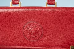 Red leather breifcase with handle and Medusa pattern Gianni Versace Circa 1980's