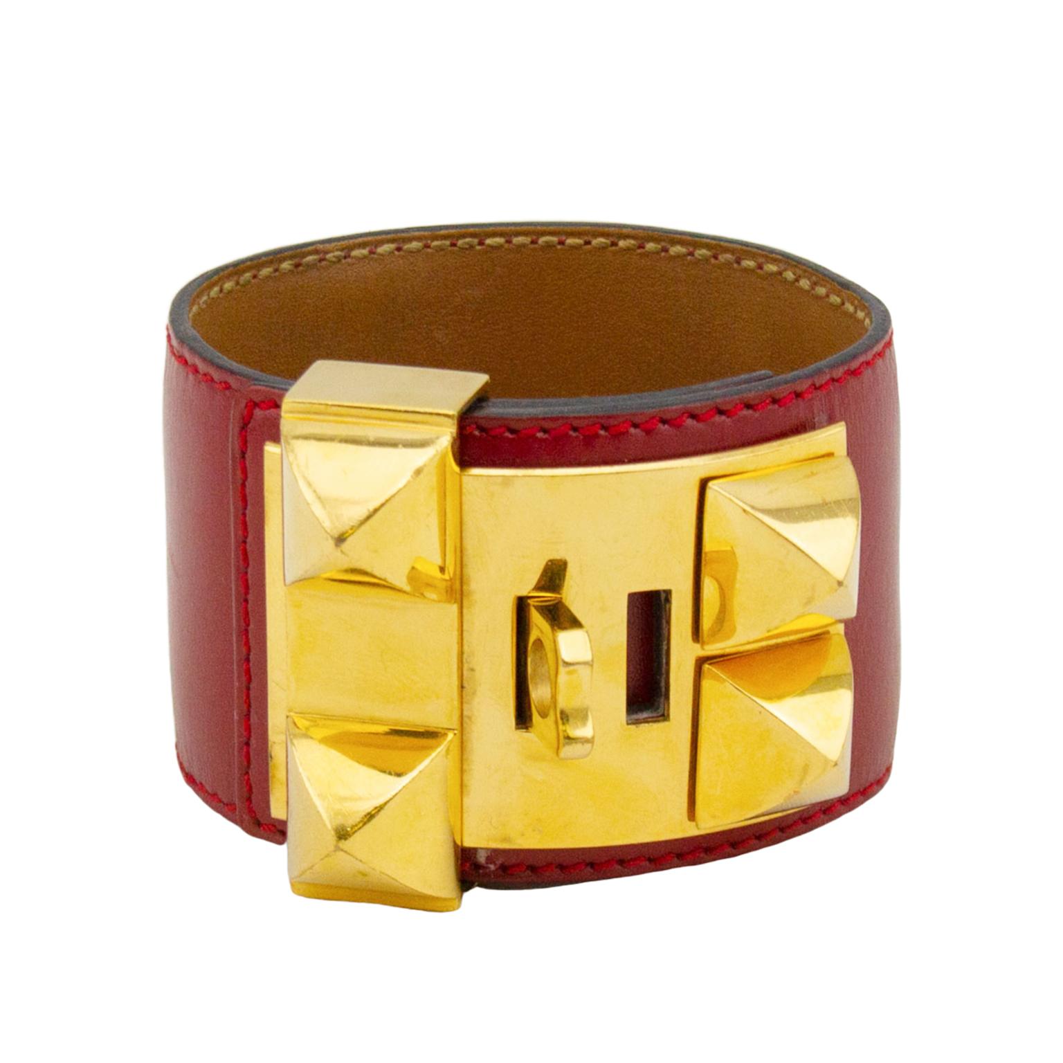 Classic and ever so collectable, the Hermes Collier de Chien bracelet cuff is a must have piece of jewelry. This red box leather cuff has gold tone hardware and can be adjusted to 4 different settings. The underside of the bracelet is a rich brown