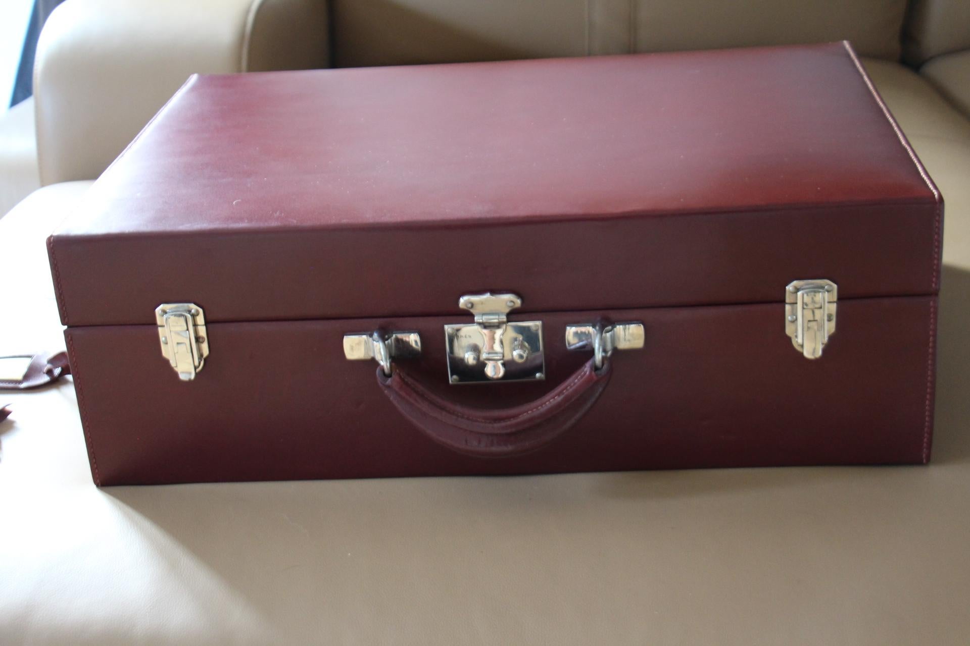 Spectacular calf box red leather suitcase. It features one leather top handle, nickel-plated brass hardware.Its two flip clasps as well as its one pinch lock closure are marked Hermes Paris .Very clean original red canvas interiors with alcantara