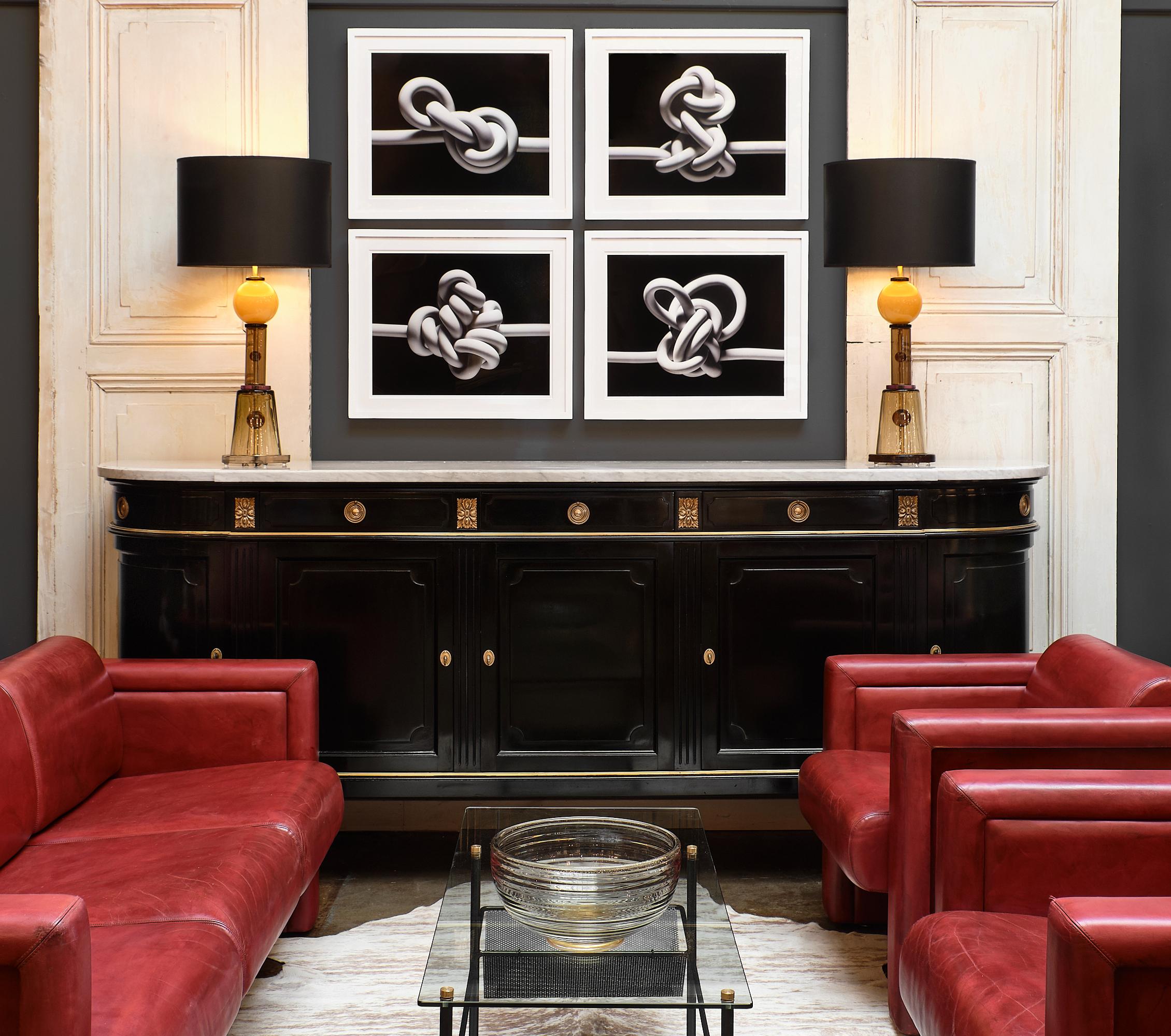 Pair of red leather Knoll armchairs in the style of Afra Tobias Scarpa. The pair has a metal frame with high density foam and the original red leather in good condition. We love the patina and post-modern lines of the pair.