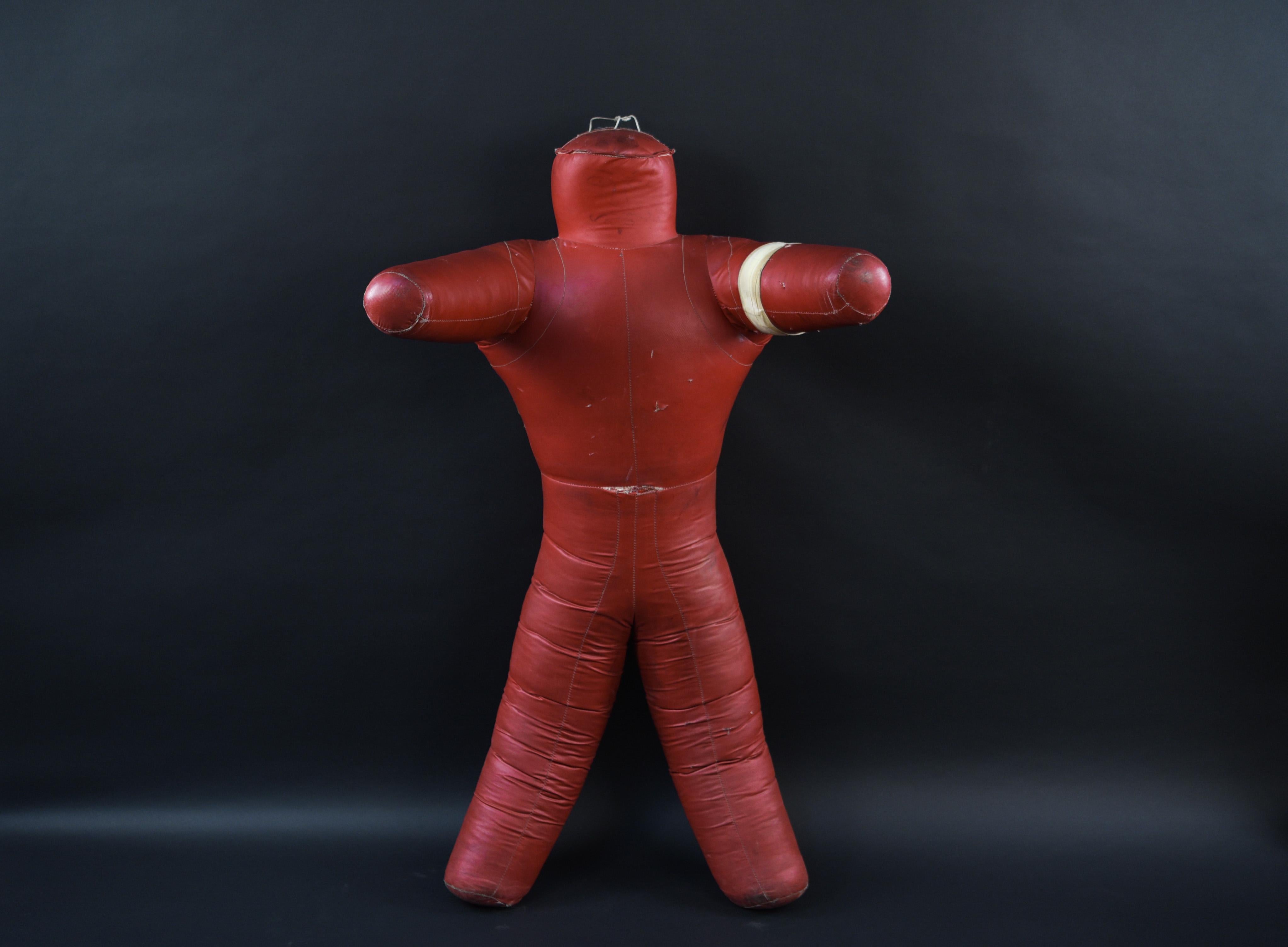 This vintage wrestling dummy or throwing dummy is in a striking red leather. This fun piece would bring an air of humor and lightheartedness to any space.