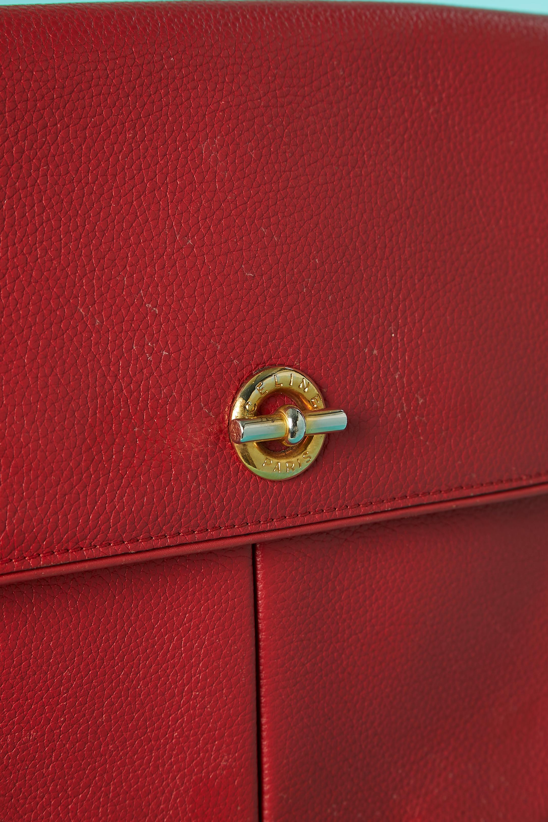 Red leather shoulder bag with gold metal hardware; 2 snap closure under the flap on top of 2 pockets. One flat pocket on the back of the bag with snap closure. One flat pocket inside the bag. 
SIZE 25cm X 22cm X 6cm
Shoulder strap lenght = 120cm (