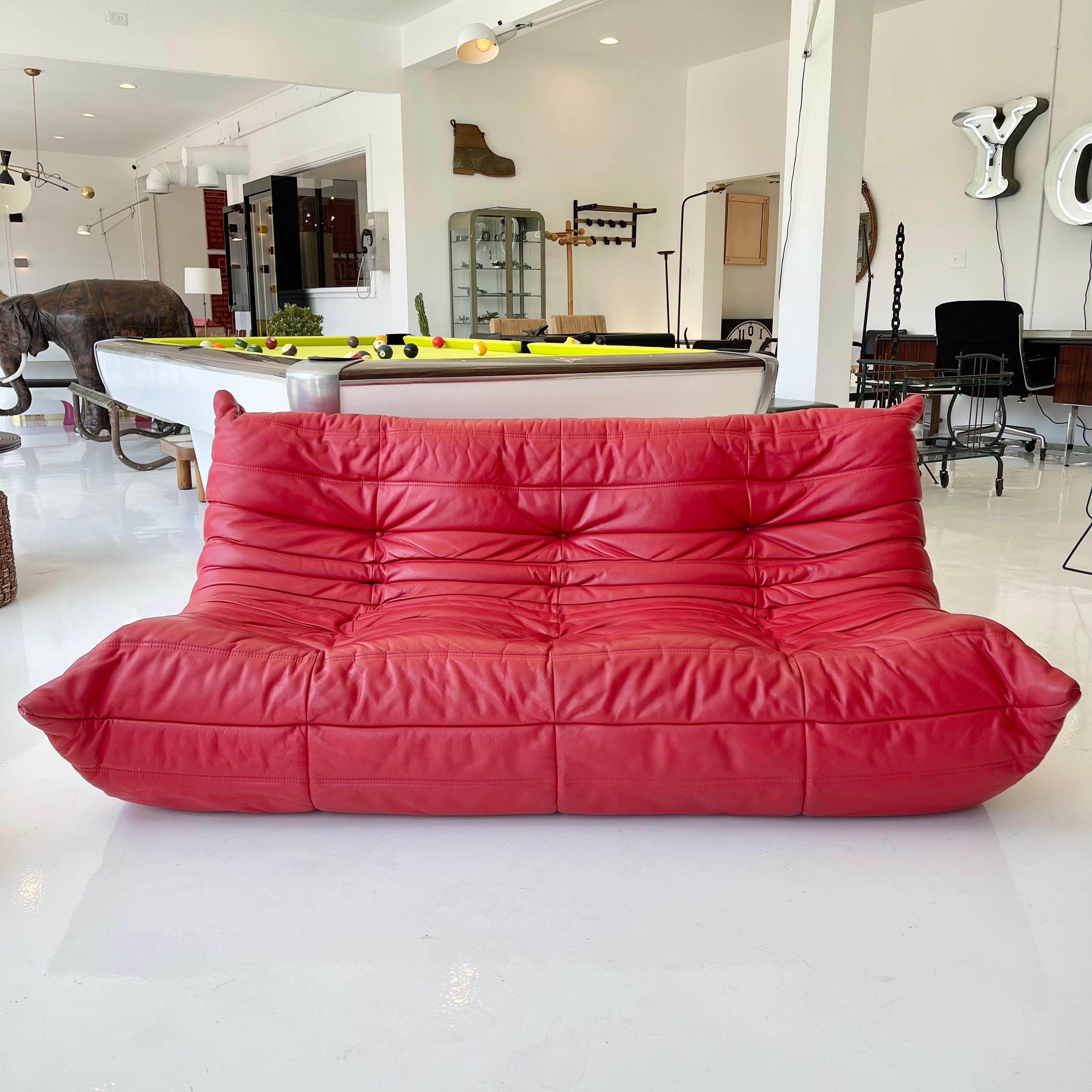 Classic French 3 seater Togo sofa by Michel Ducaroy for luxury brand Ligne Roset. Originally designed in the 1970s the iconic togo sofa is now a design classic. This sofa comes in its original vintage red leather.

Timeless comfort and style make