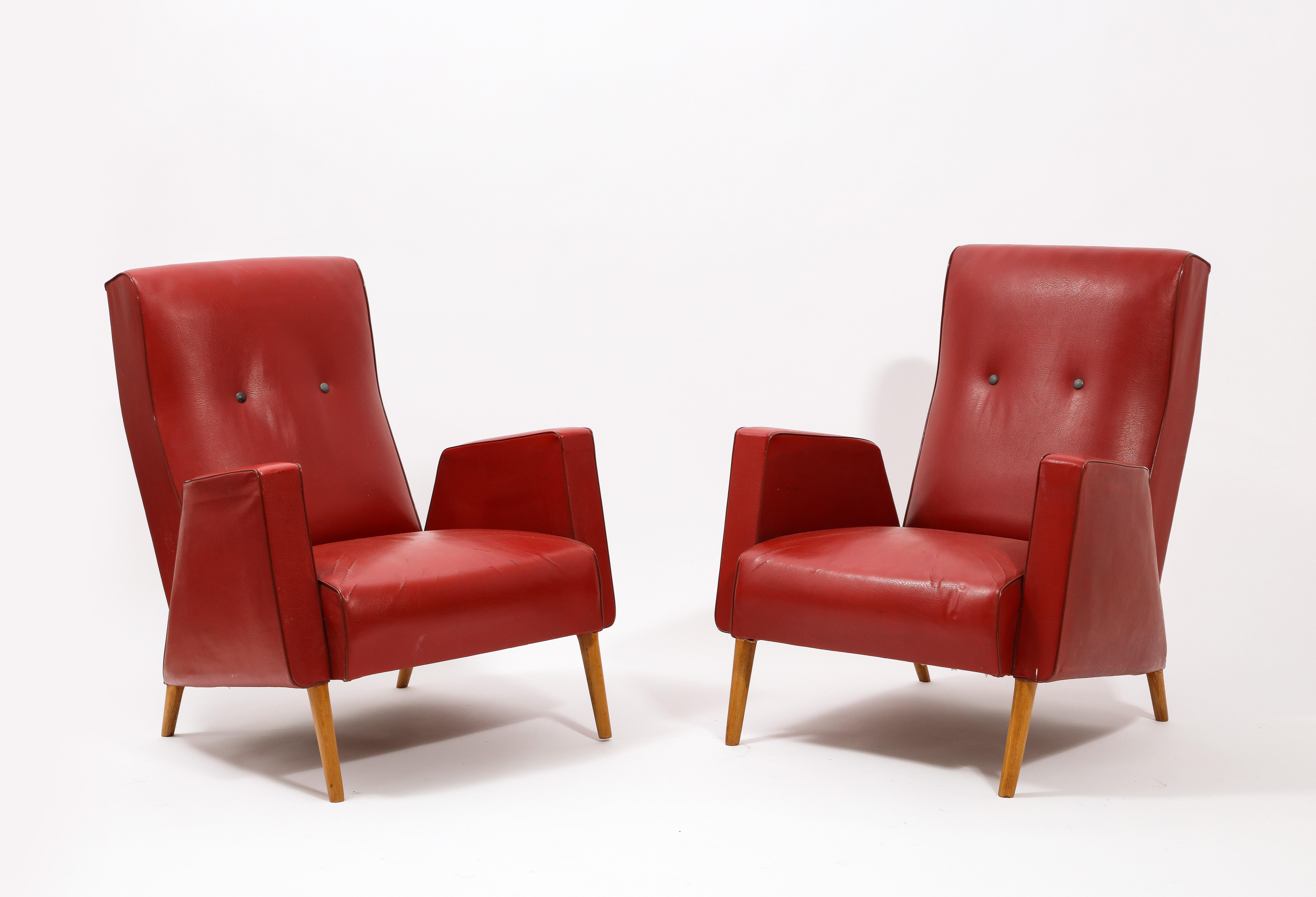 Early pair of Louis Paolozzi armchairs in original waxed canvas on solid elm legs.
Upholstery in COM is available.
