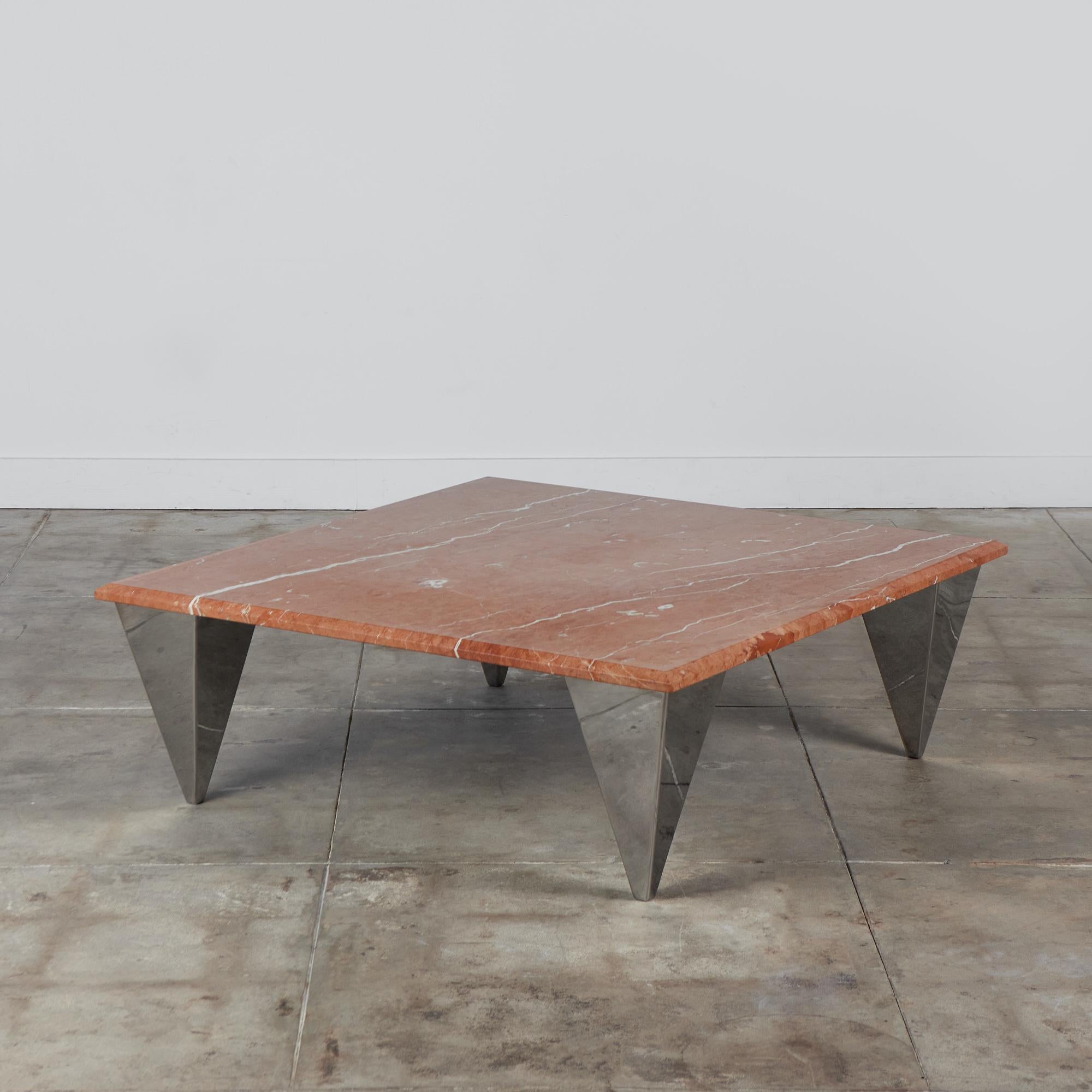 Square red marble postmodern coffee table. The table features a thick square Rojo Alicante marble and four angular chrome legs that taper towards the bottom. The legs reflect the tables surrounds giving it a floating effect.

Dimensions: 50