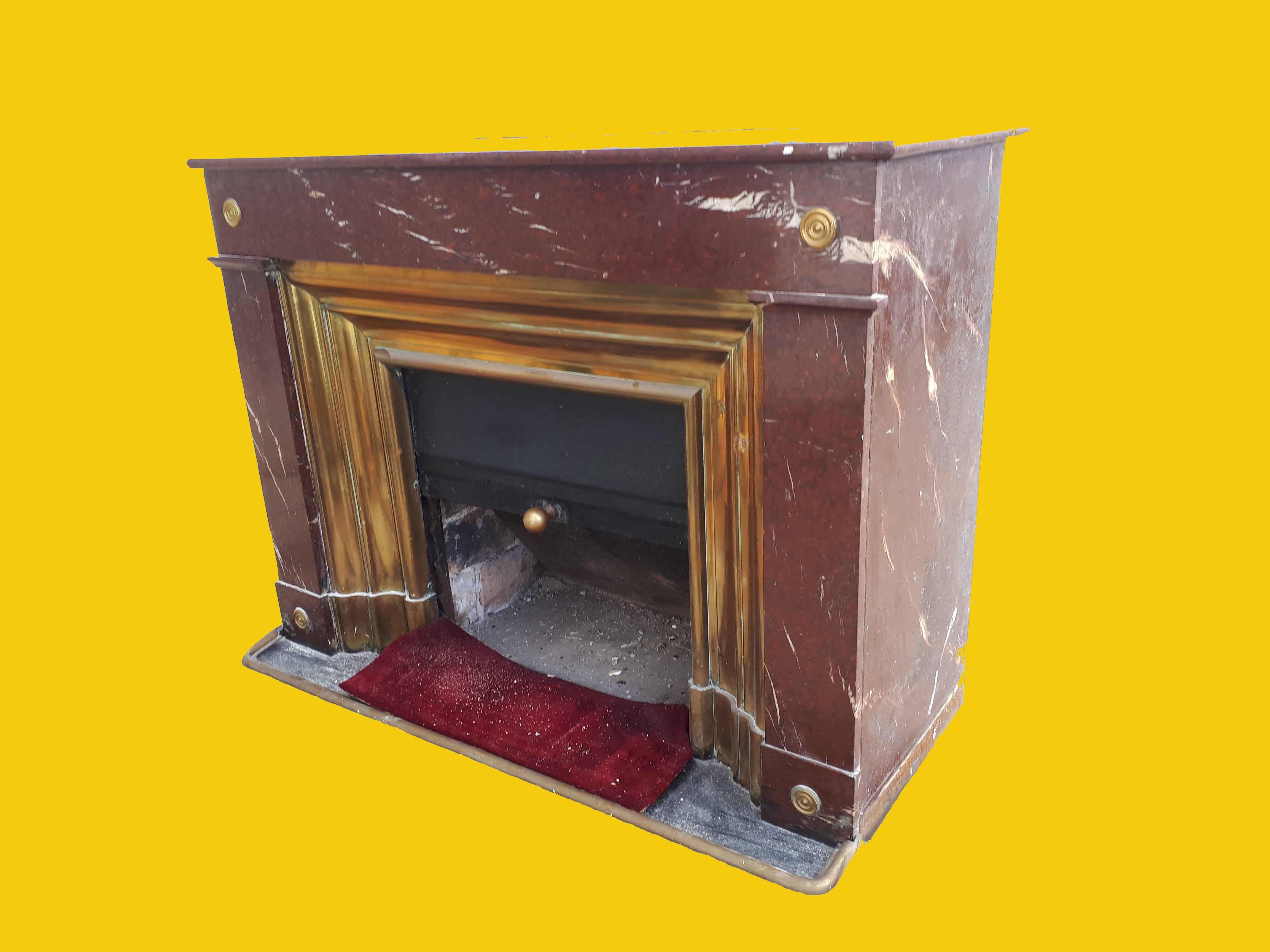 A most unusual and rare red and cream flecked marble fireplace circa 1890 with brass molded inserts and a slide to cover the opening when not in use.