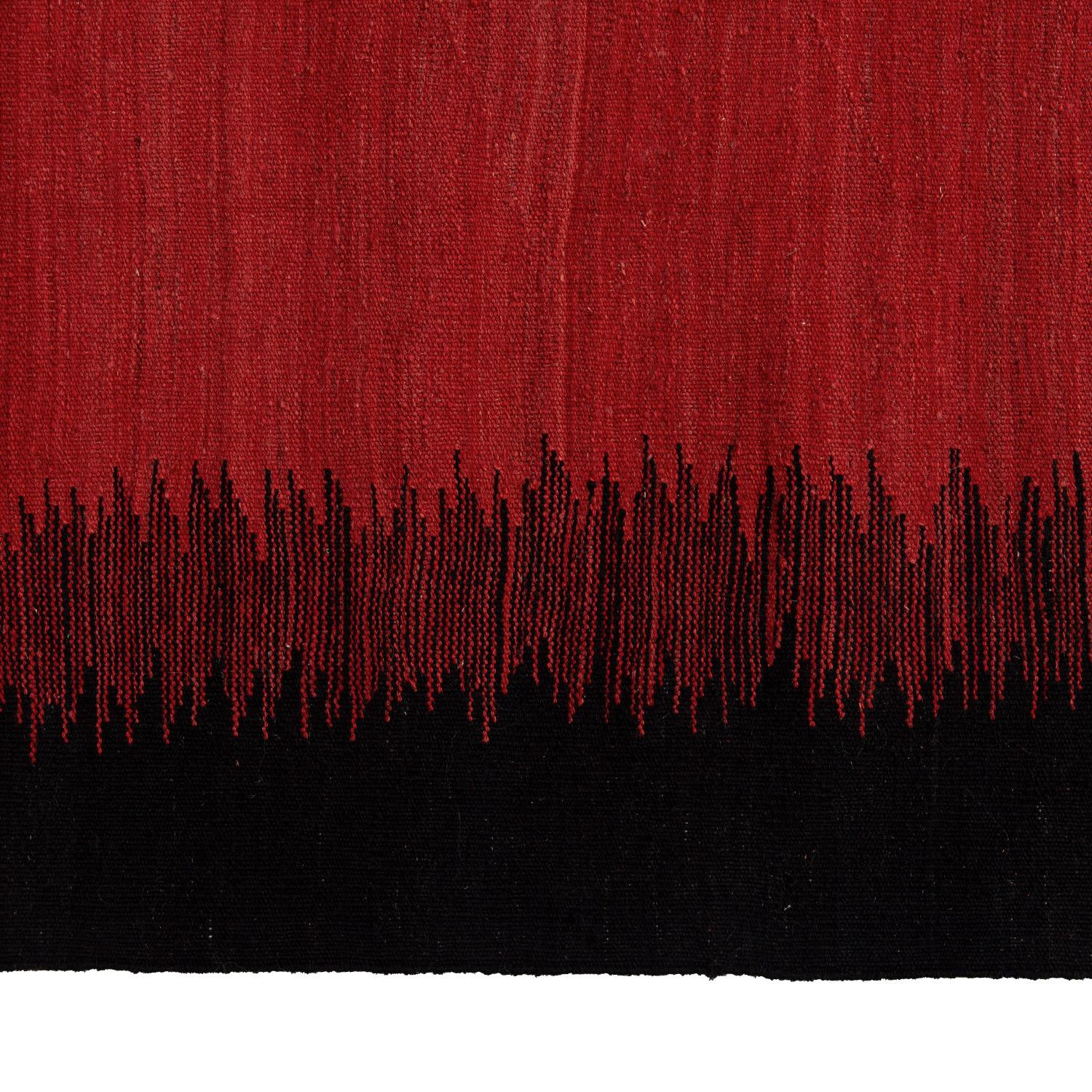 Handwoven from wool in the Mazandaran province of Turkey, this Antique Flatweave Rug - 6'x8' features an abstract pattern in a color palette of deep brown and vibrant vermillion. This area rug is created on a loom and threaded through the warps,