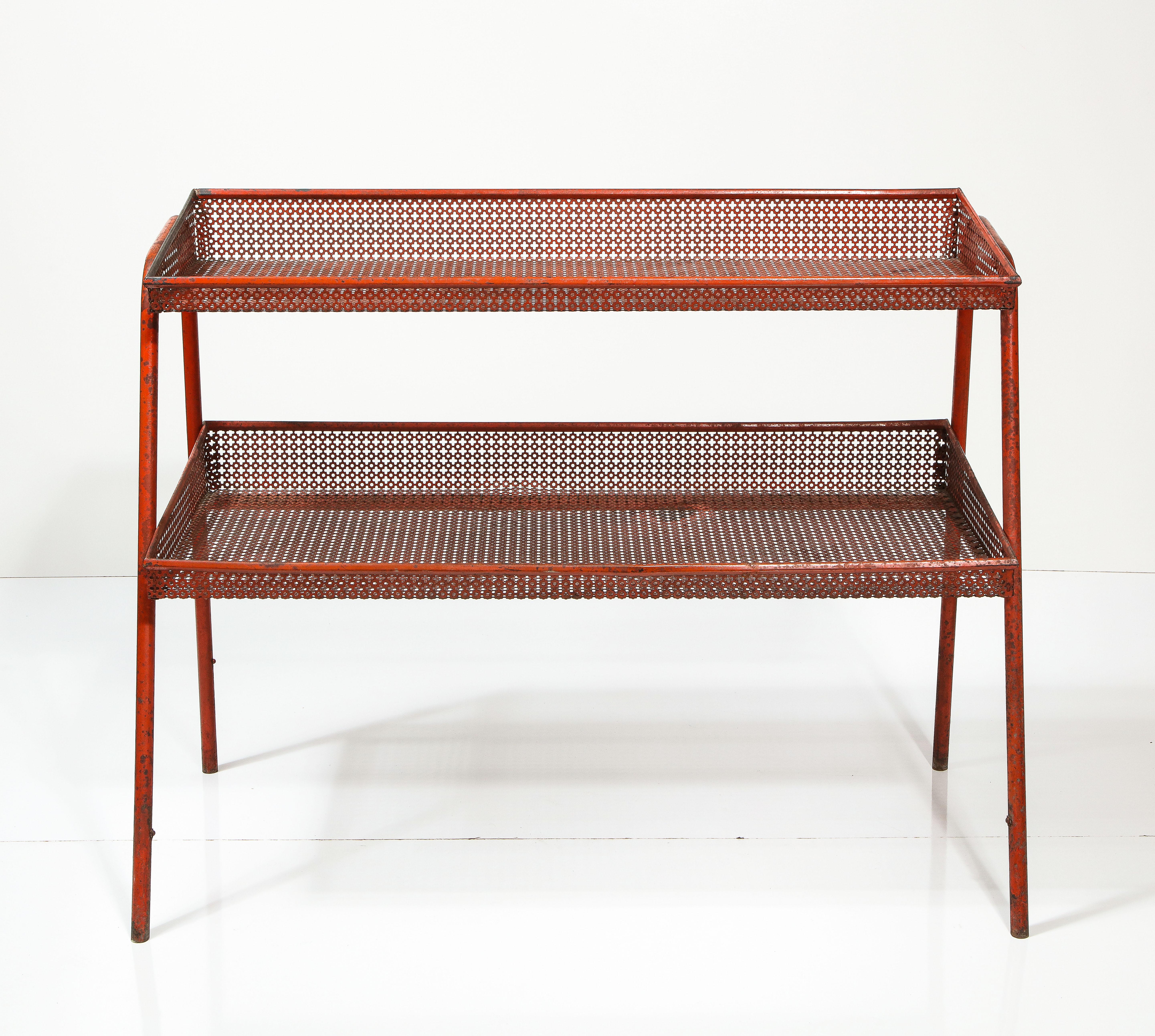 Painted, patinated red metal shelf with unique hole pattern, attributed to Mathieu Mategot