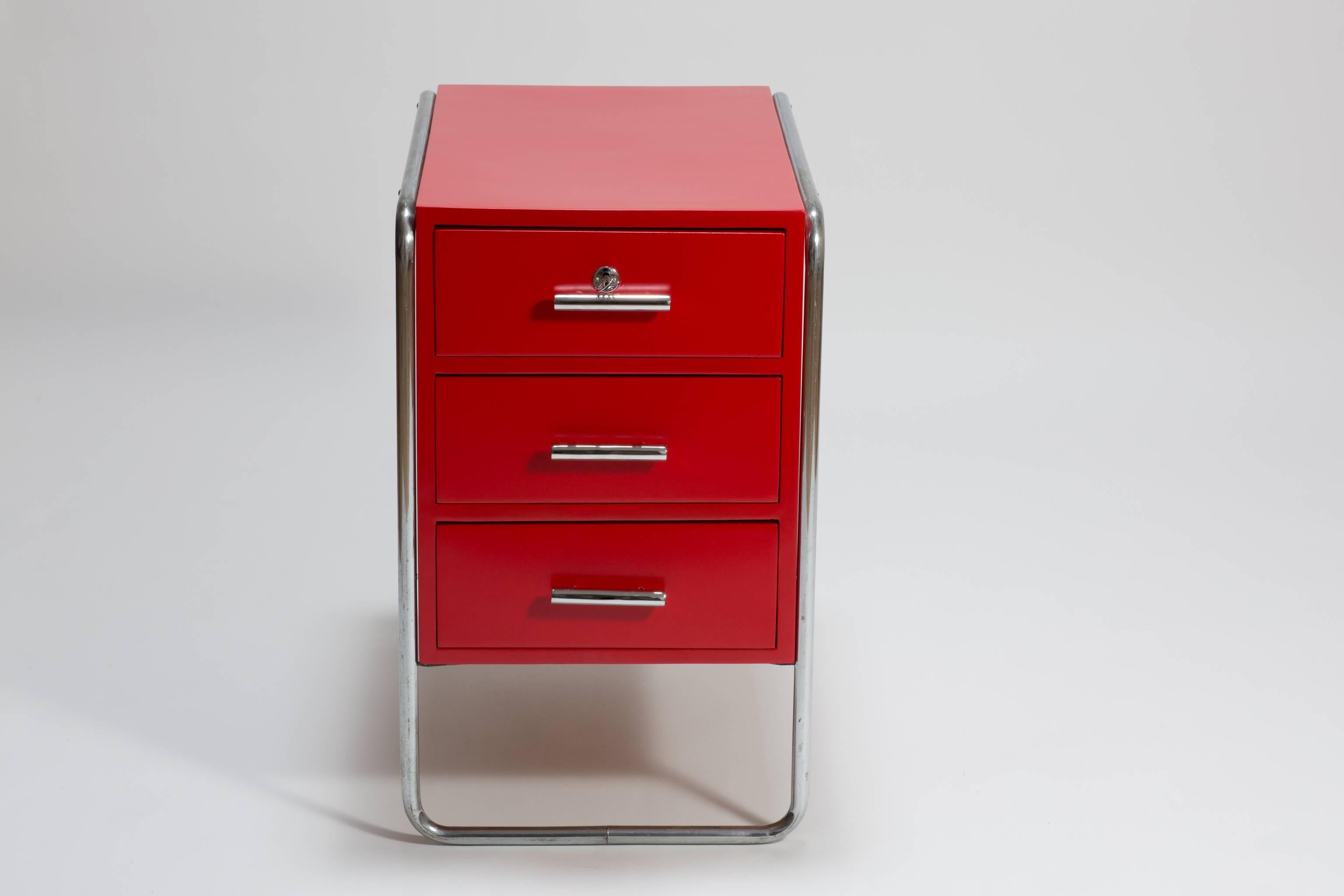 Original red midcentury Bauhaus writing desk container designed by Marcel Breuer, circa 1930. The container was produced by Muecke & Melder around 1930 and has a makers mark at the back. The container has three drawers with original locks and keys