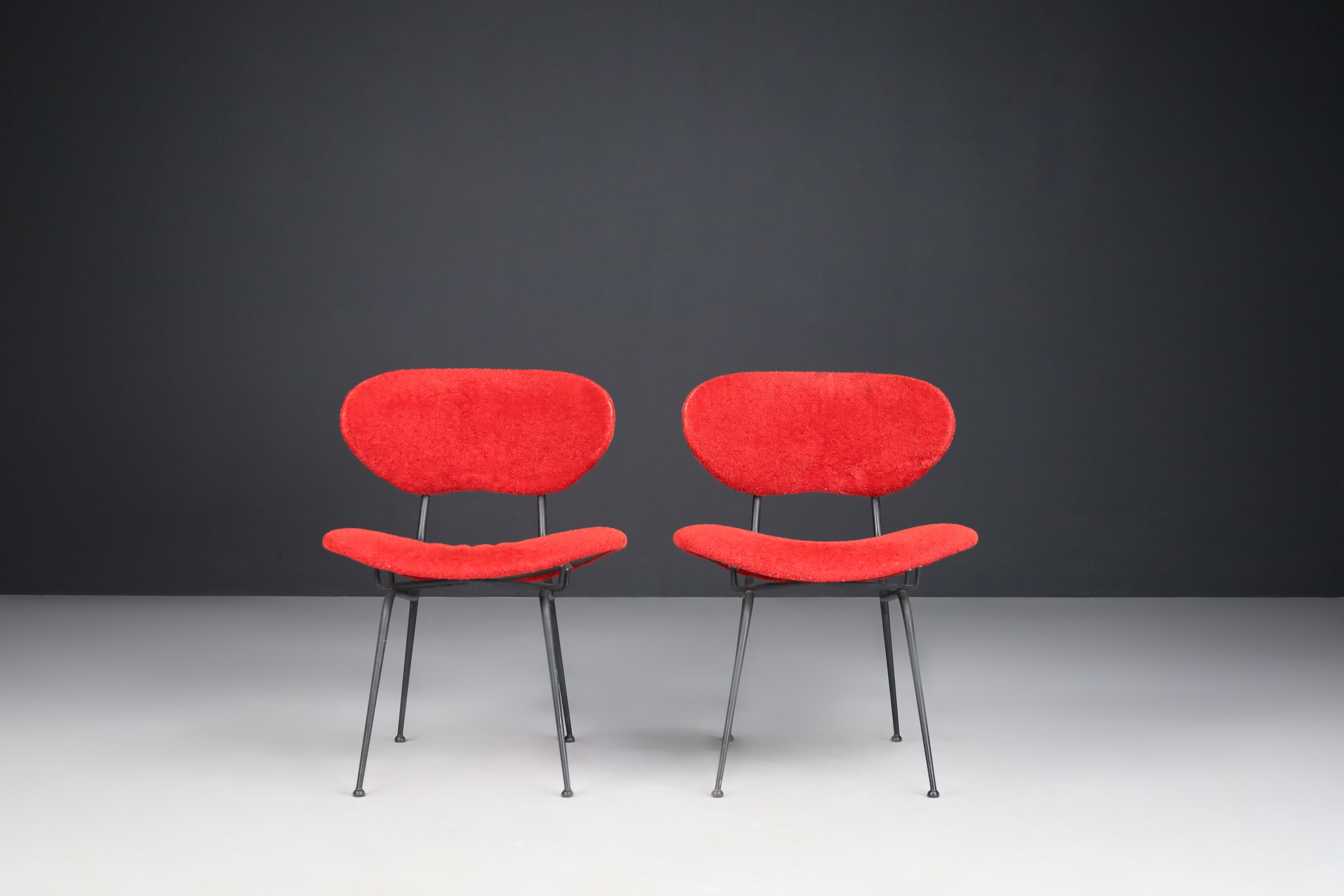 Red Mid-Century Modern armchairs by Gastone Rinaldi, Italy 1960s.
 
Gastone Rinaldi designed this beautiful and iconic pair of rare chairs in 1954, Italy. The shape of the chairs is sculptural, unique, and elegant. The legs of the chairs are very