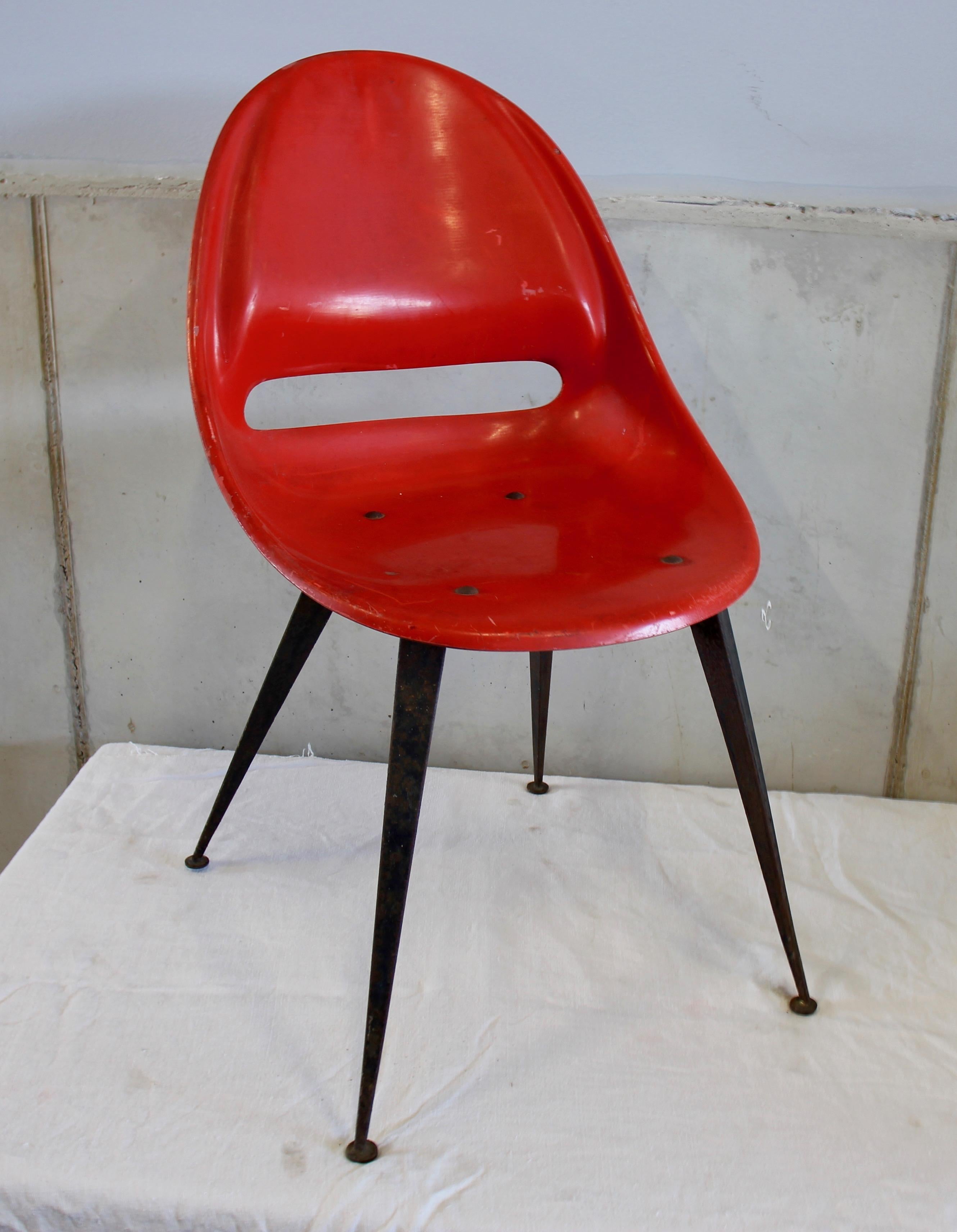 This vibrant red chair made in the 1950s in the Czech republic.
The legs are made out of black painted metal. There are some signs of use on the seatings and there is a bit of rost on the legs. The chairs are very stabile and are a real eyecatcher!