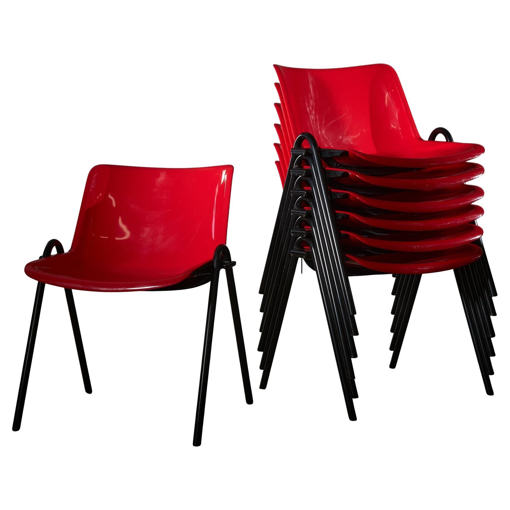 Designed by Osvaldo Borsani for Tecno in 1982, the Modus chairs are crafted from ABS plastic, a material known for its durability, and feature a glossy red finish that pairs well with the black tubular steel frame. These chairs serve multiple