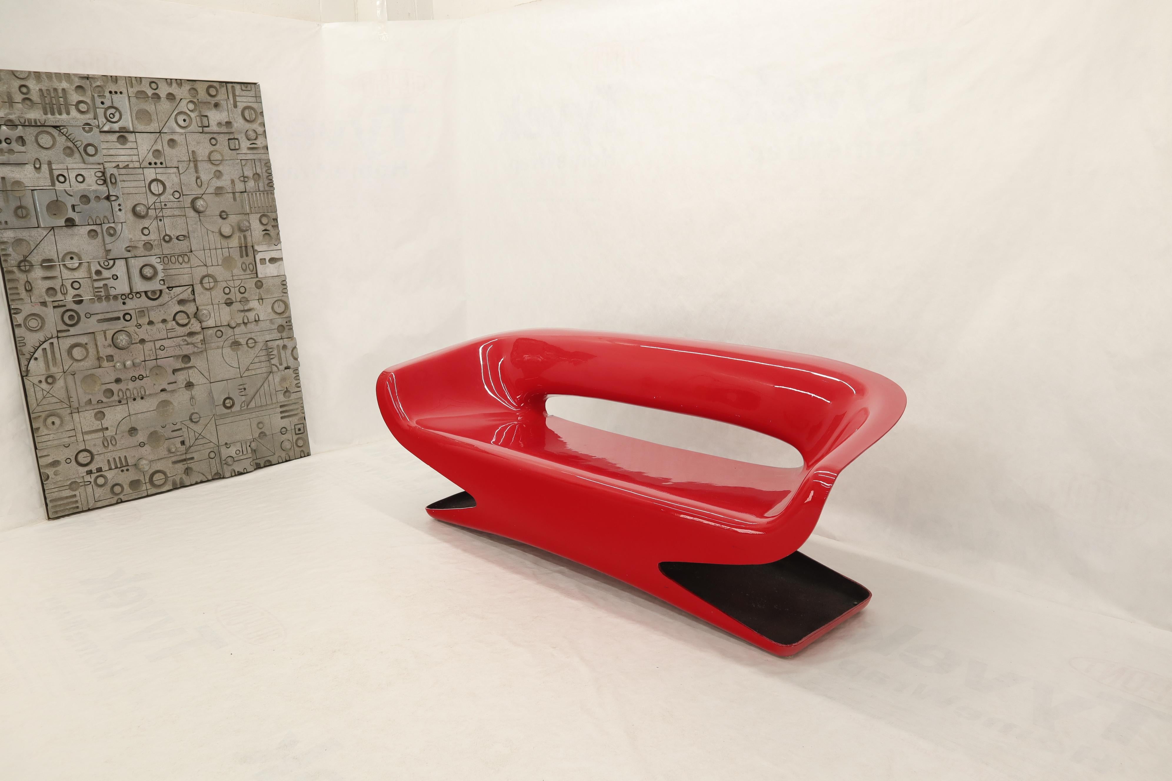 Mid century modern fire red one molded fiberglass piece bench loveseat sofa couch. Sculptural ultra modern design piece of furniture.
  