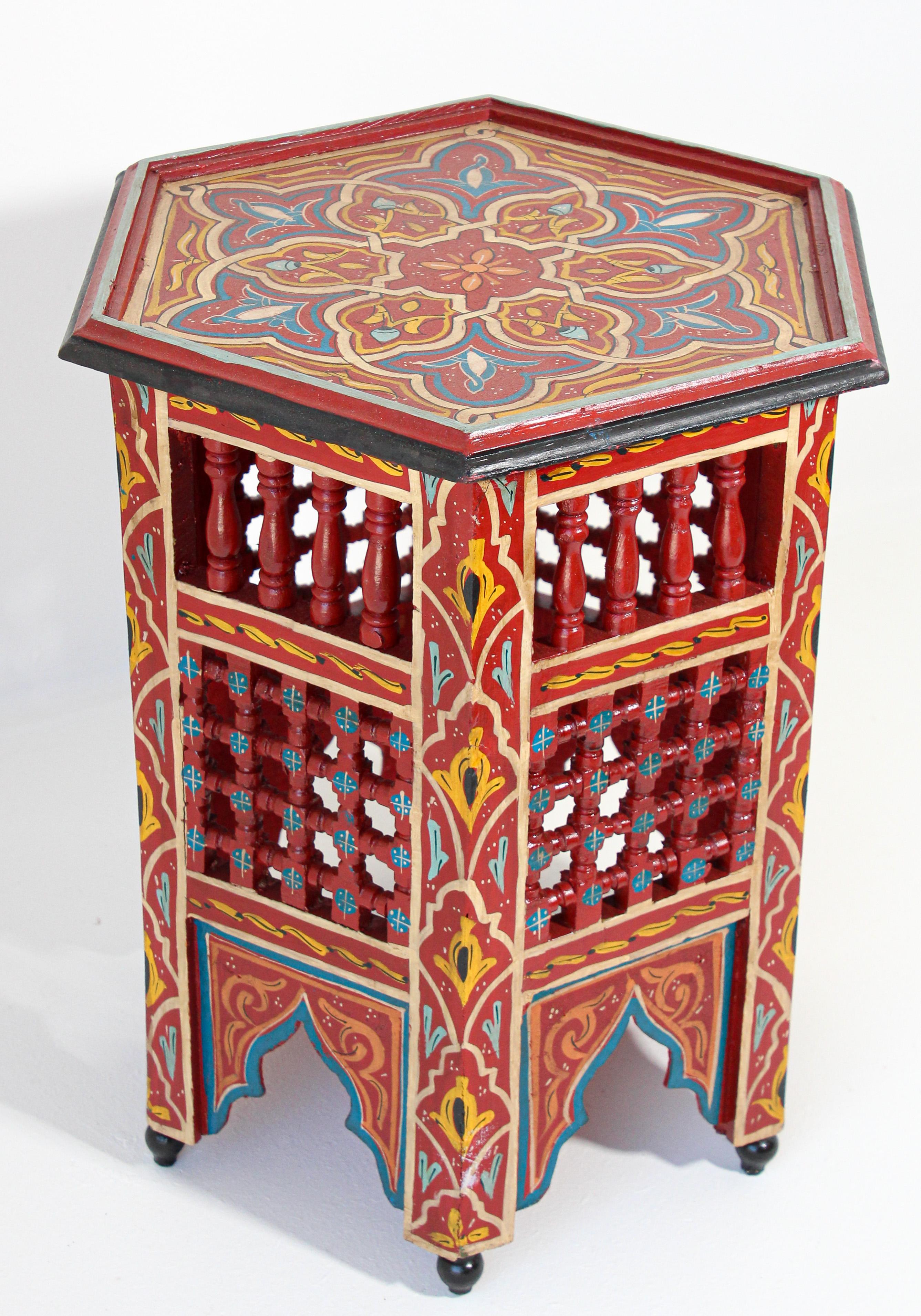 Moroccan handcrafted and hand painted side table.
Moucharabie fret work octagonal stool with Moorish arches.
Handcrafted in Hispano Moresque style and hand painted on red color background with wine, aqua, green and ochre Moorish floral and
