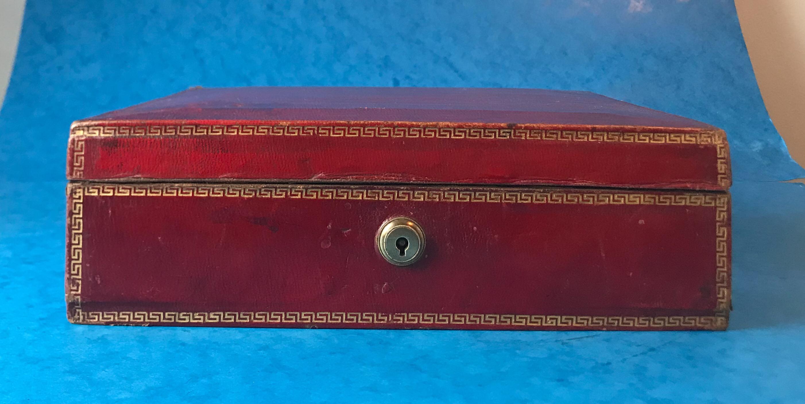 A rare Georgian 1820 red Moroccan leather jewelry box
It has a Grecian key gilt design around the edges of the box.
The jewelry box features a very early Brahma lock, unfortunately it doesn’t come with a key.
The jewelry box has it’s original