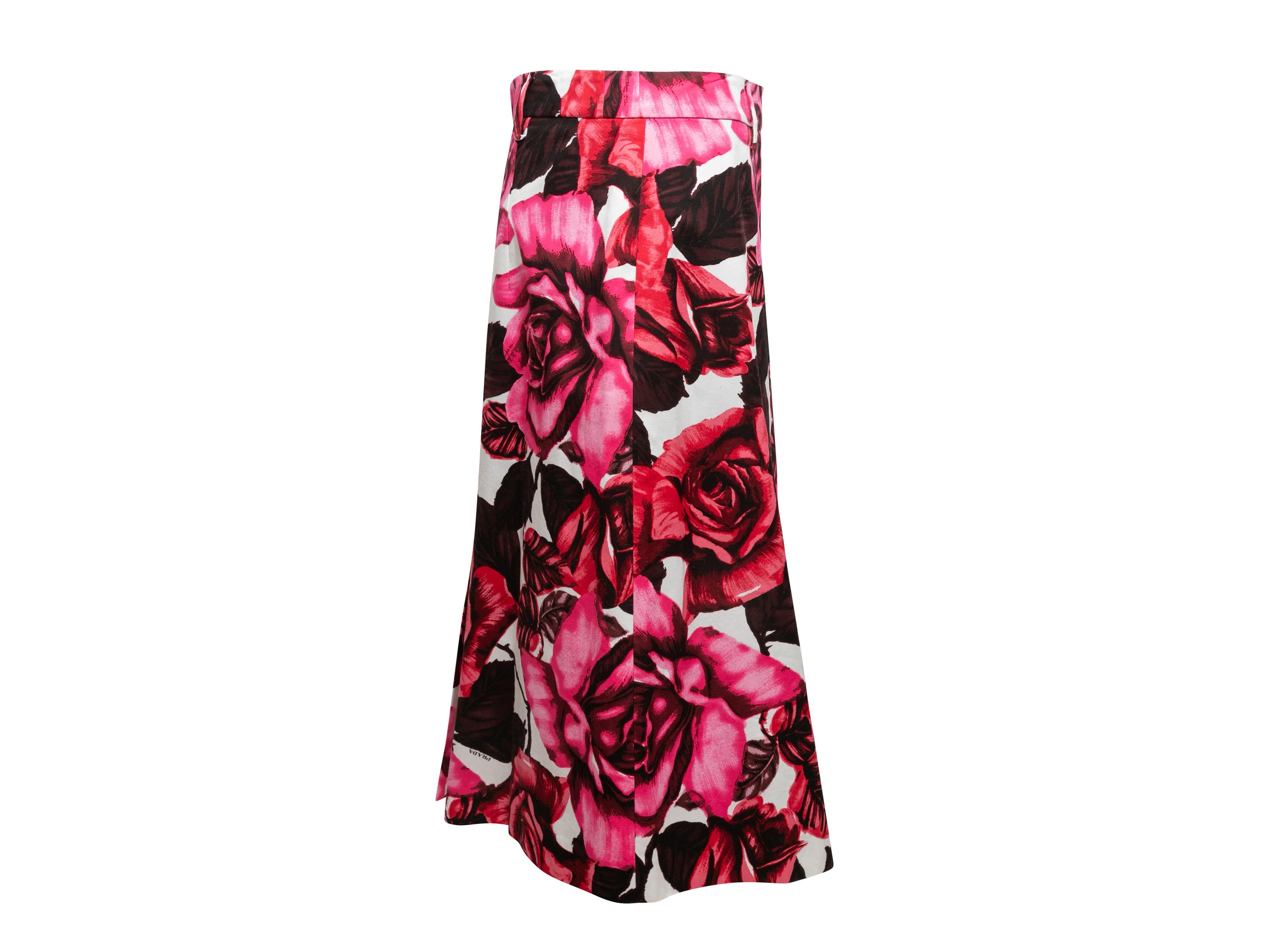 Red and multicolor 2019 rose print skirt by Prada. Belt loops at waist. Zip closure at side. 33