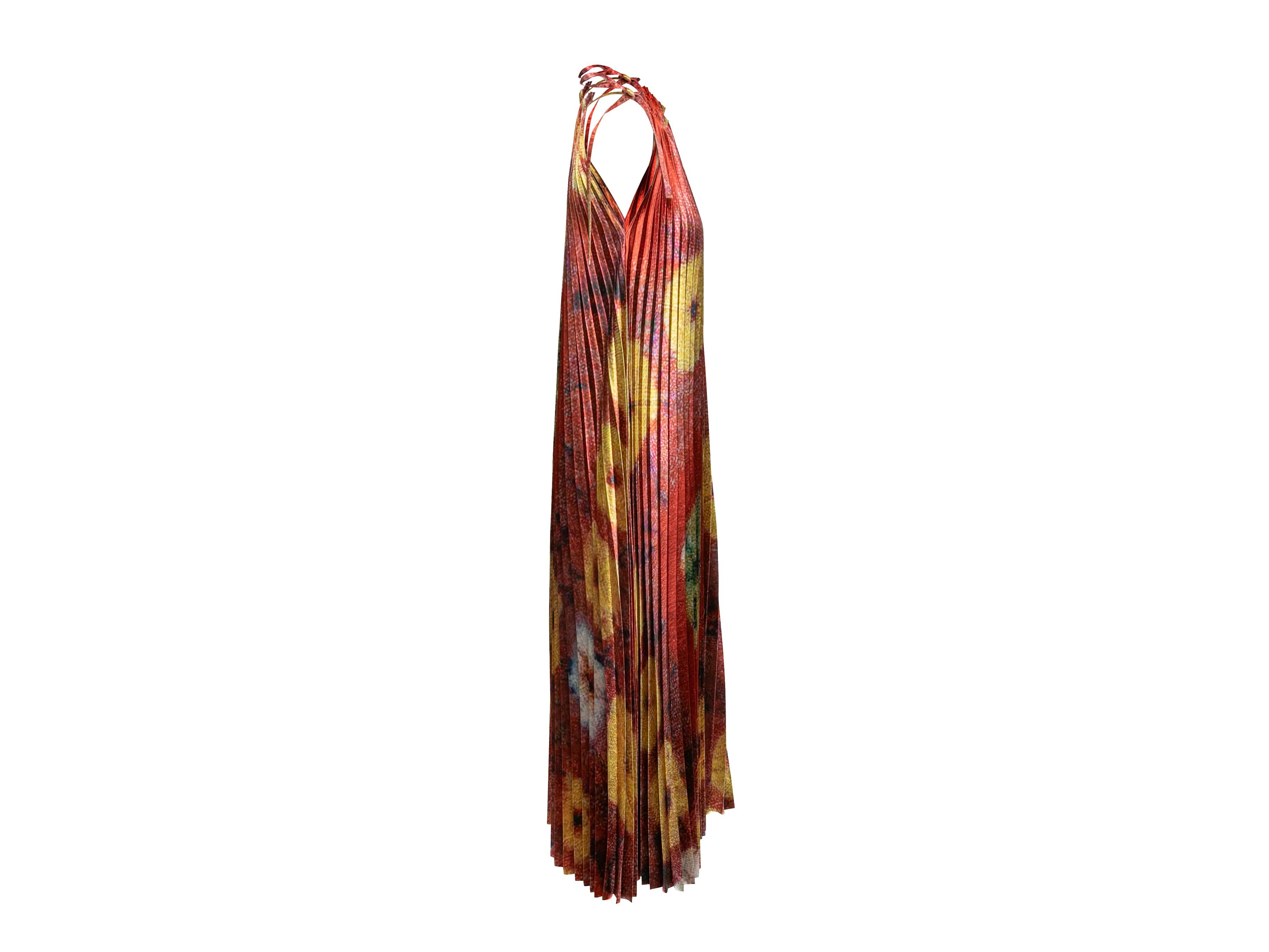 Product Details: Red and multicolor pleated sleeveless maxi dress by Ulla Johnson. Crew neck. Abstract tie-dye floral print throughout. Tie closure at side of neckline. 36