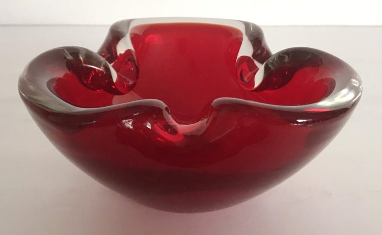 Vintage red triangular Murano glass ashtray or candy bowl / Made in Italy, circa 1960s 
Measures: diameter 6 inches, height 3 inches 
1 in stock in Palm Springs ON 50% OFF SALE for $449 !!
Order Reference #: FABIOLTD G195
This piece makes for great