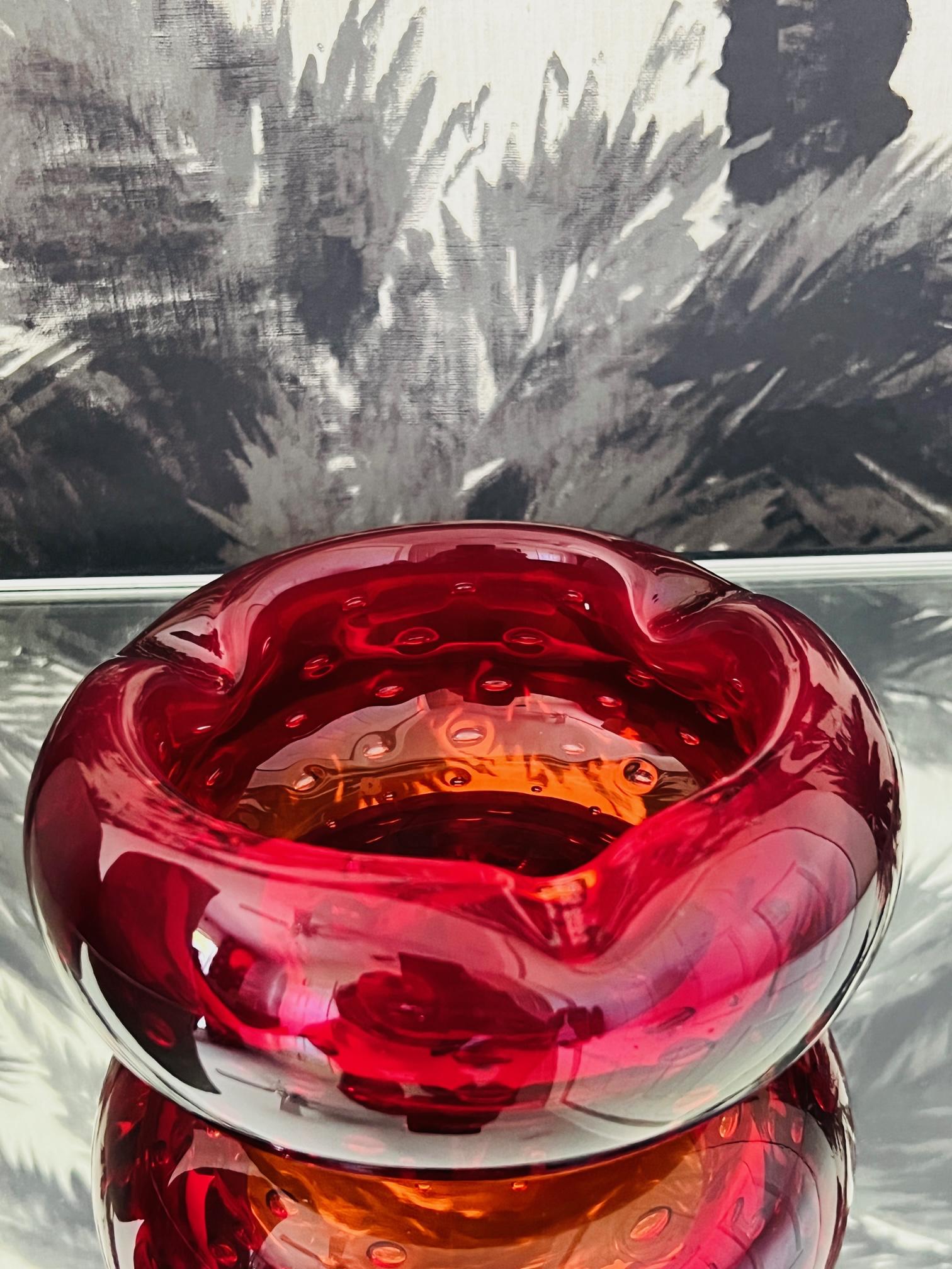 Mid-Century Modern Venetian glass ashtray in hues of deep red. Handblown chunky glass with beautiful rounded form featuring controlled bubble accents and curved notches along the rim. Can be also be used as a decorative object, vide poche or a