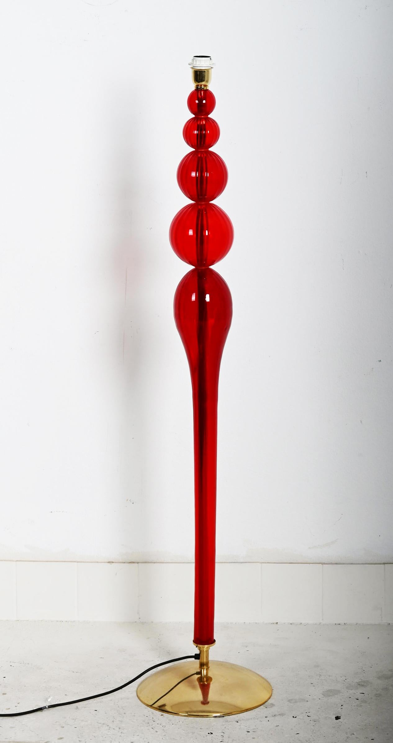Rare brass base and center bar. Hand blown red glass elements fitted with one E27 socket. Shade is on request possible. 