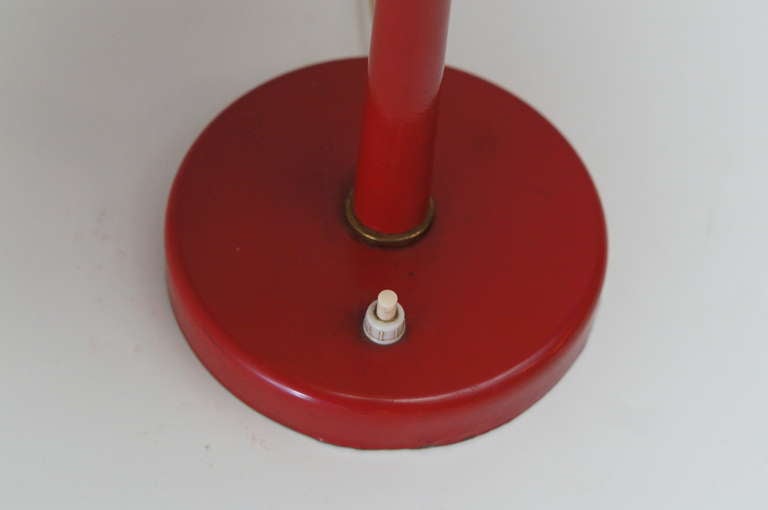 VEB Leuchtenbau red mushroom desk lamp.
Materials: Red painted iron base and aluminium lampshade with a brass top. Cast iron counterweight inside the base. Some metal parts. Two white bakelite sockets.

Measures: Height 47.
Diameter 35.