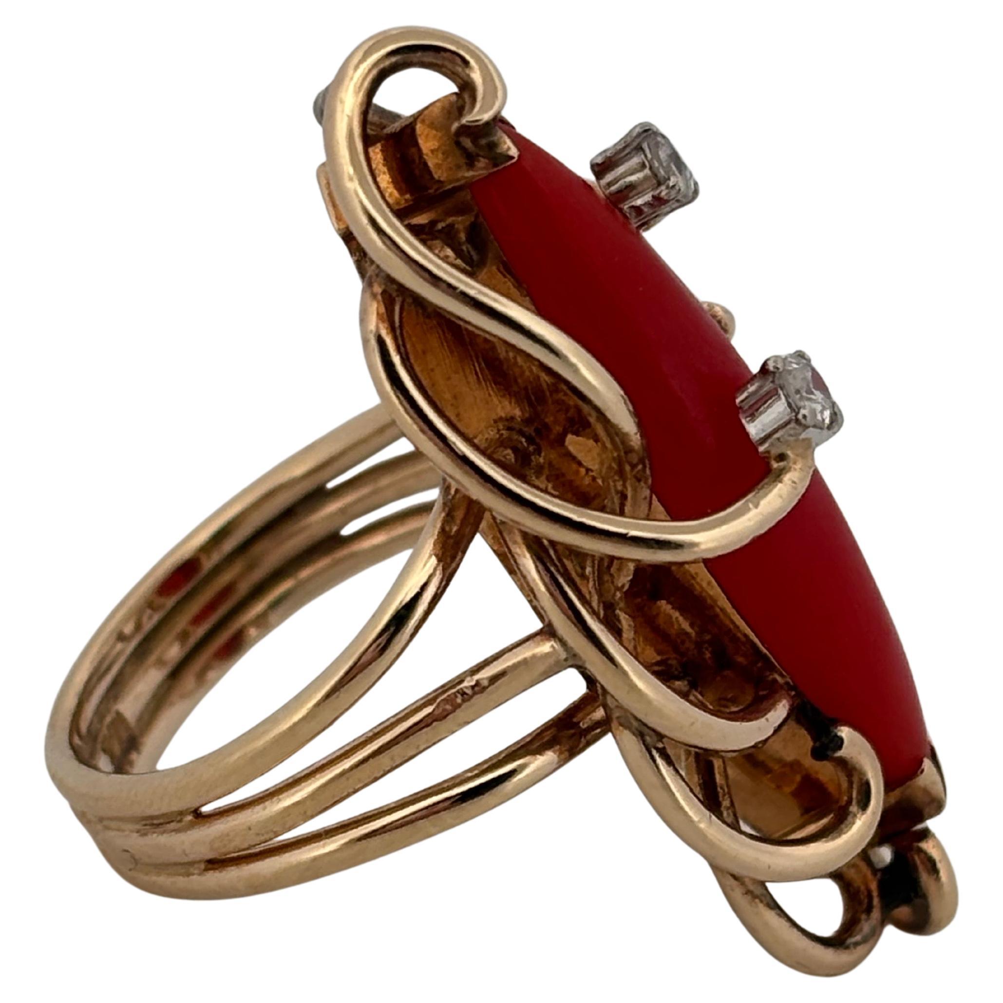 This striking vintage ring is beautifully crafted in 14k yellow gold and showcases a natural red coral centerpiece in an elongated marquise shape. Measuring 23.7mm long by 6.05mm wide, the coral displays a vivid, saturated hue that radiates warmth