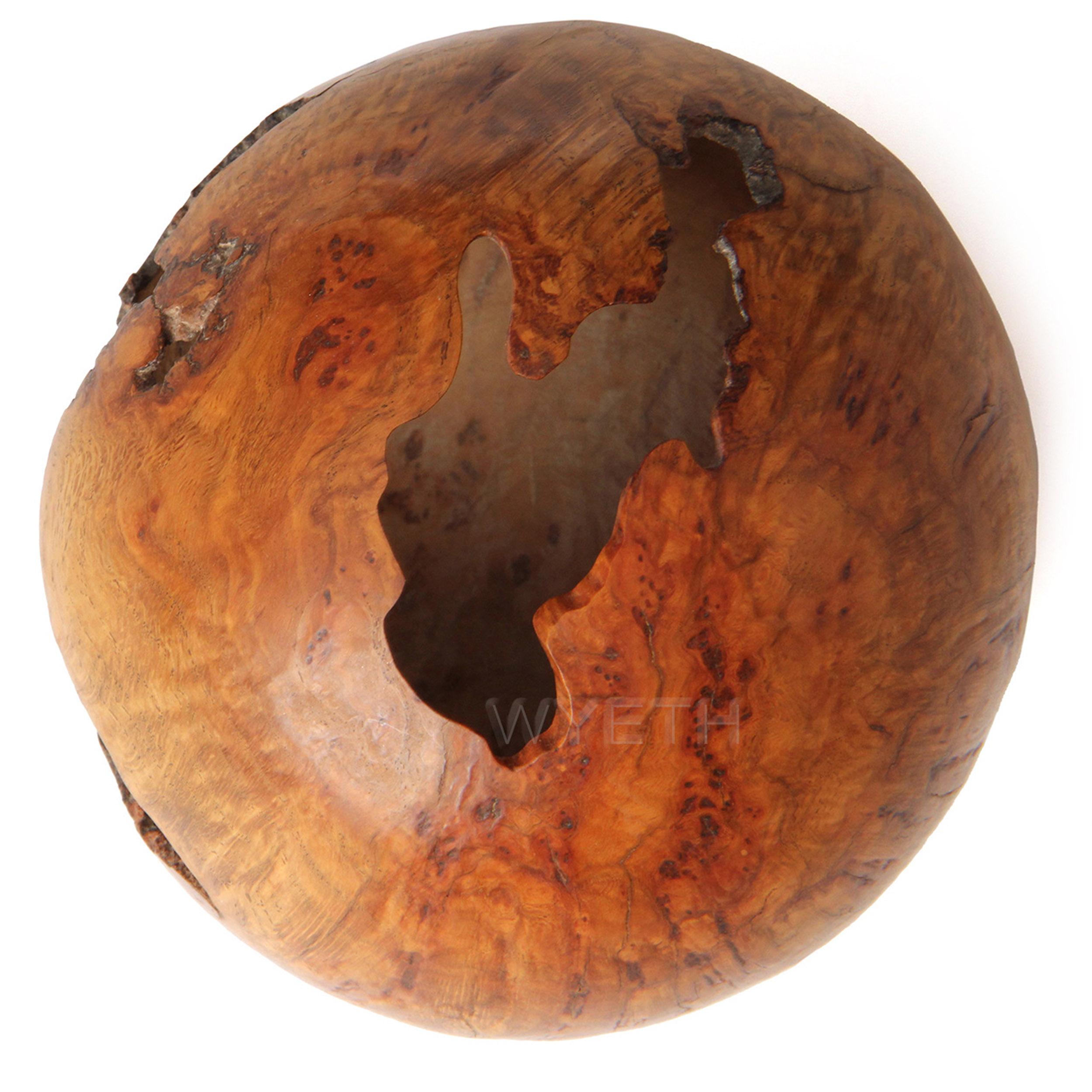 A delicate lathe turned sphere in Red Oak burl with natural occlusions. Signed 