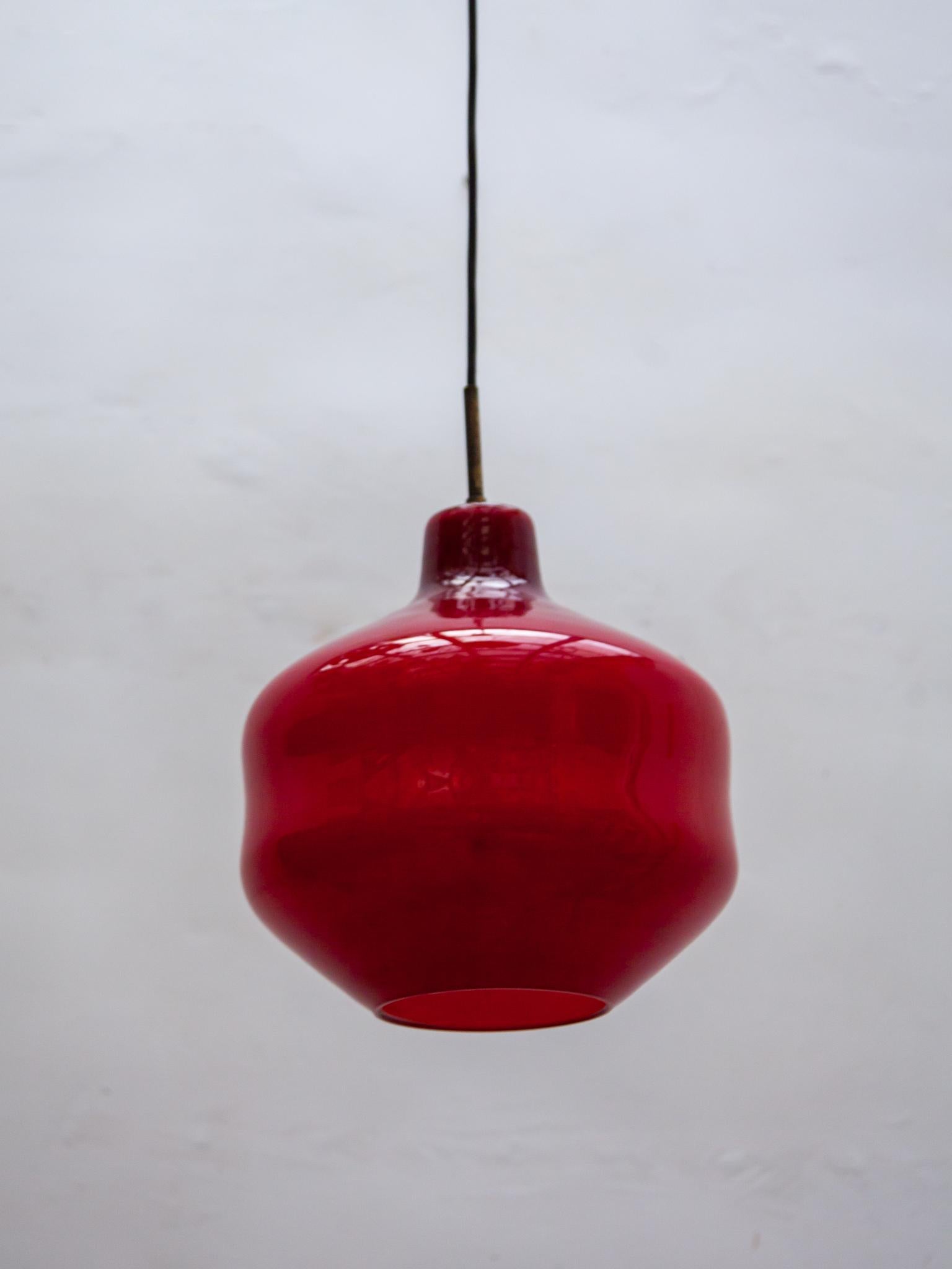 Holmgaard pendant lamp opal red glass in very good condition. Original canopy. Beautiful deep red color.

A very nice accent of light in your interior.