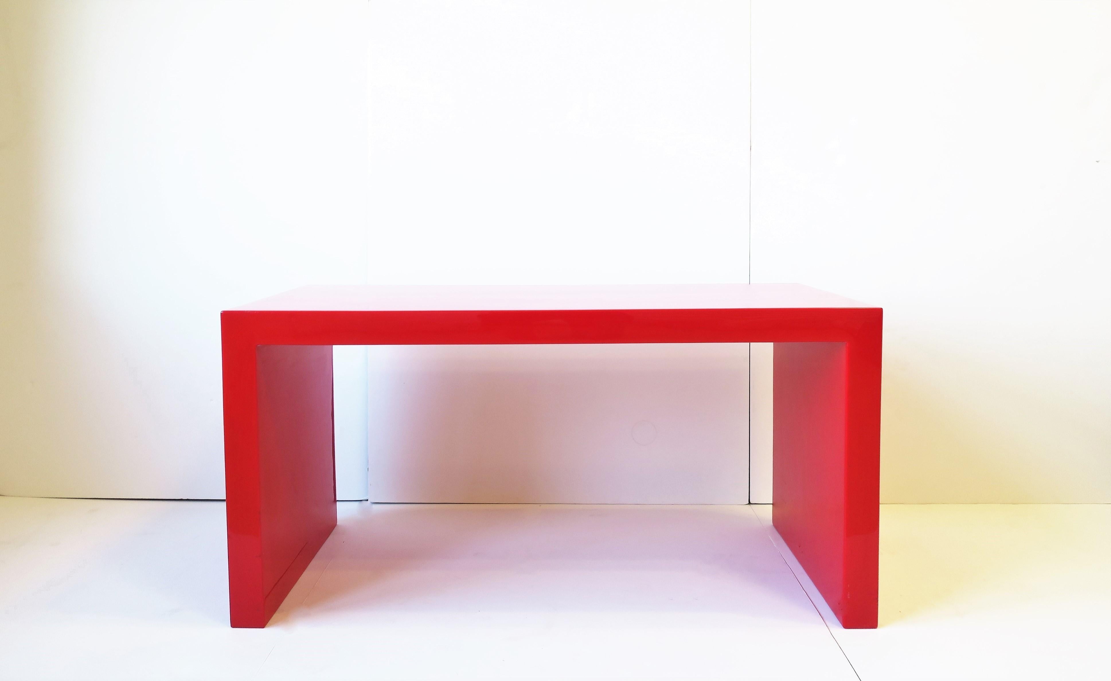 A beautiful and substantial high-gloss red opaque acrylic bench or cocktail table, circa late 20th to early 21st century. Great as a bench or coffee/cocktail table. Dimensions: 18