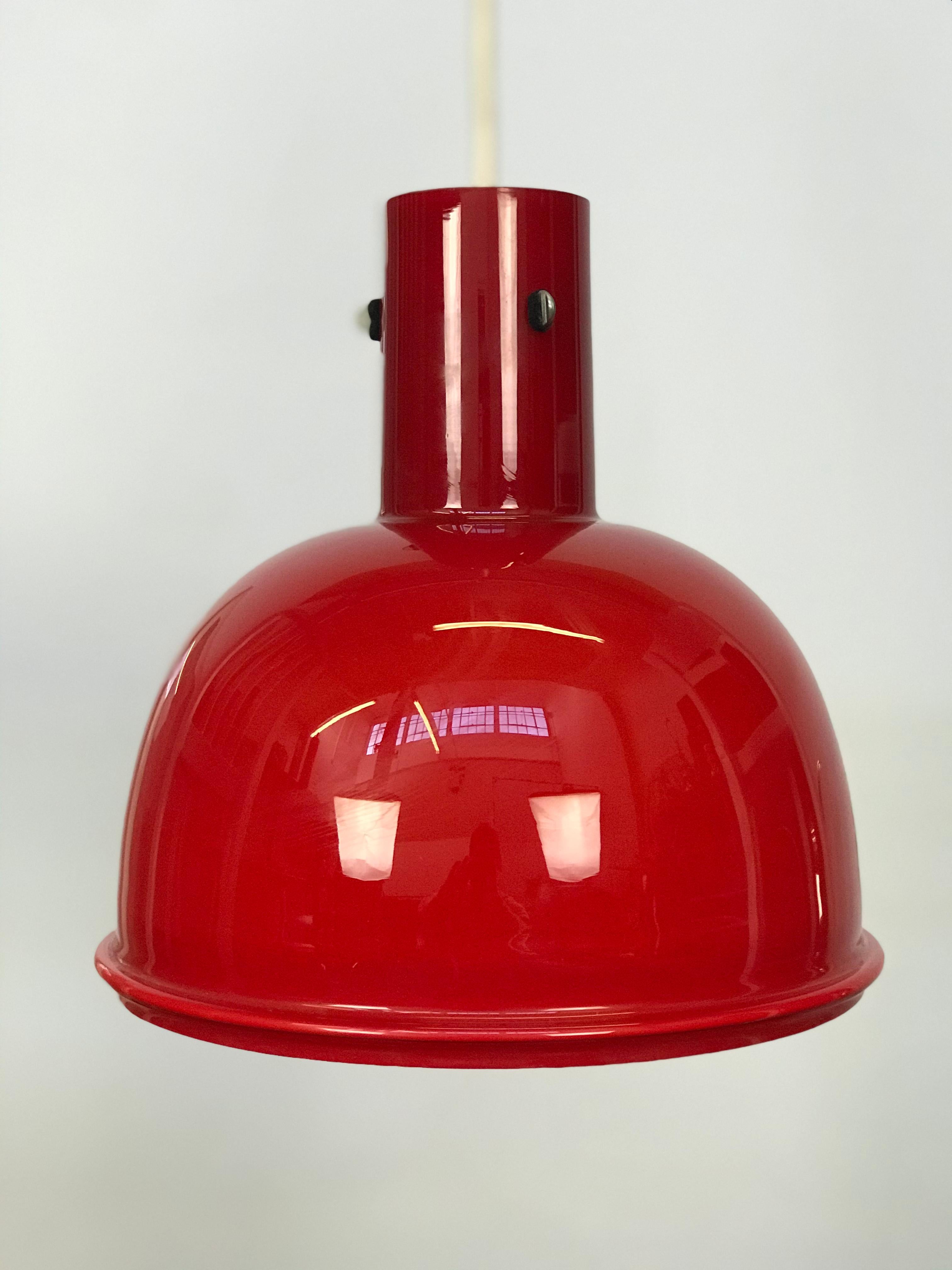 Well made thick red opaque milk glass pendant light by the noted lighting firm Glashutee Limburg for Lightolier: from the original owner. Purchased in 1979. Single cord suspension measures 26