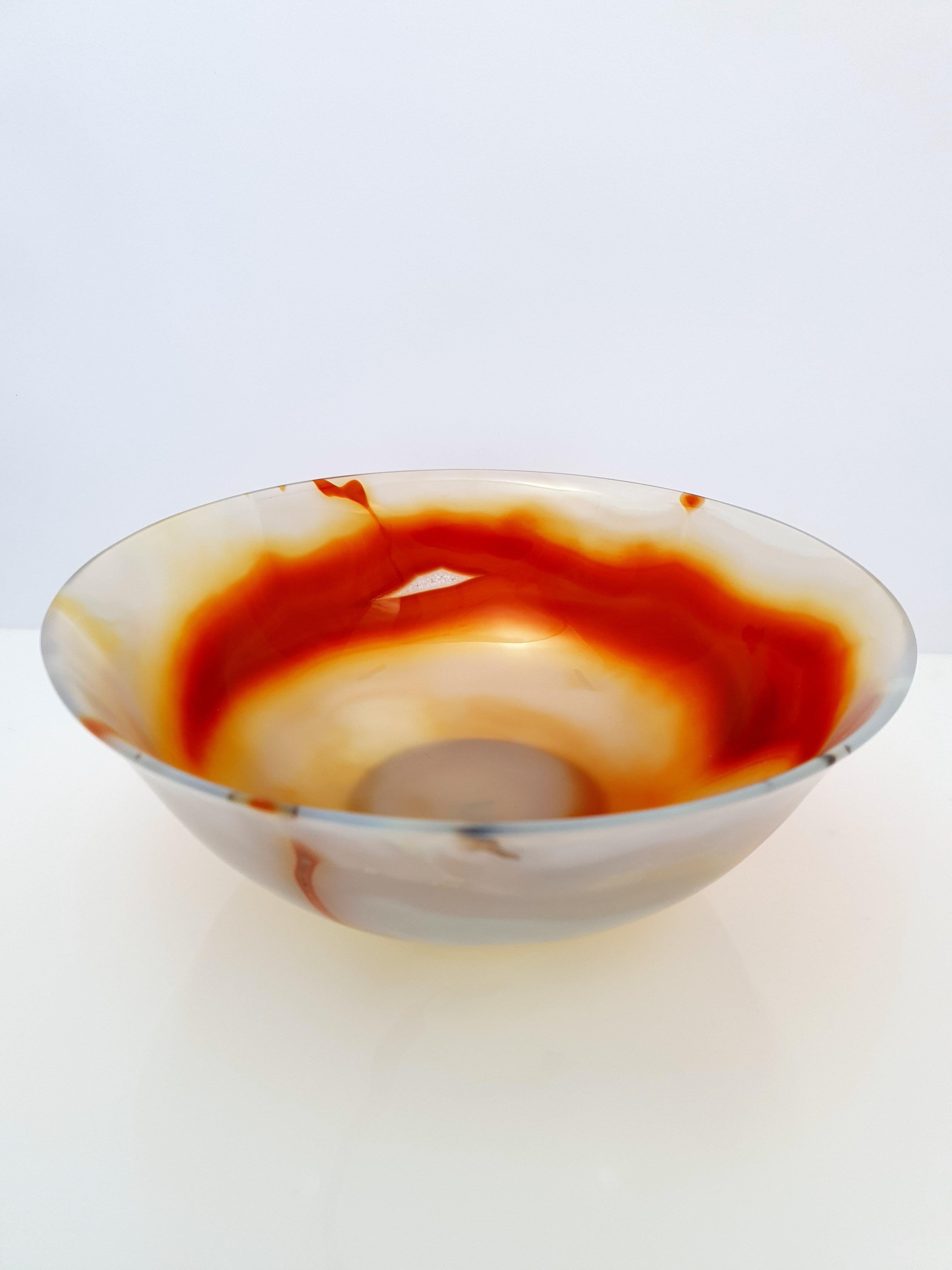 A Natural Handmade Red Orange Banded Agate Bowl.
The bowl is cut so thin that the material is translucent.

It's a great piece for decoration on a desk, vanity, or even as a special gift.
diameter: 7 1/2 inch.