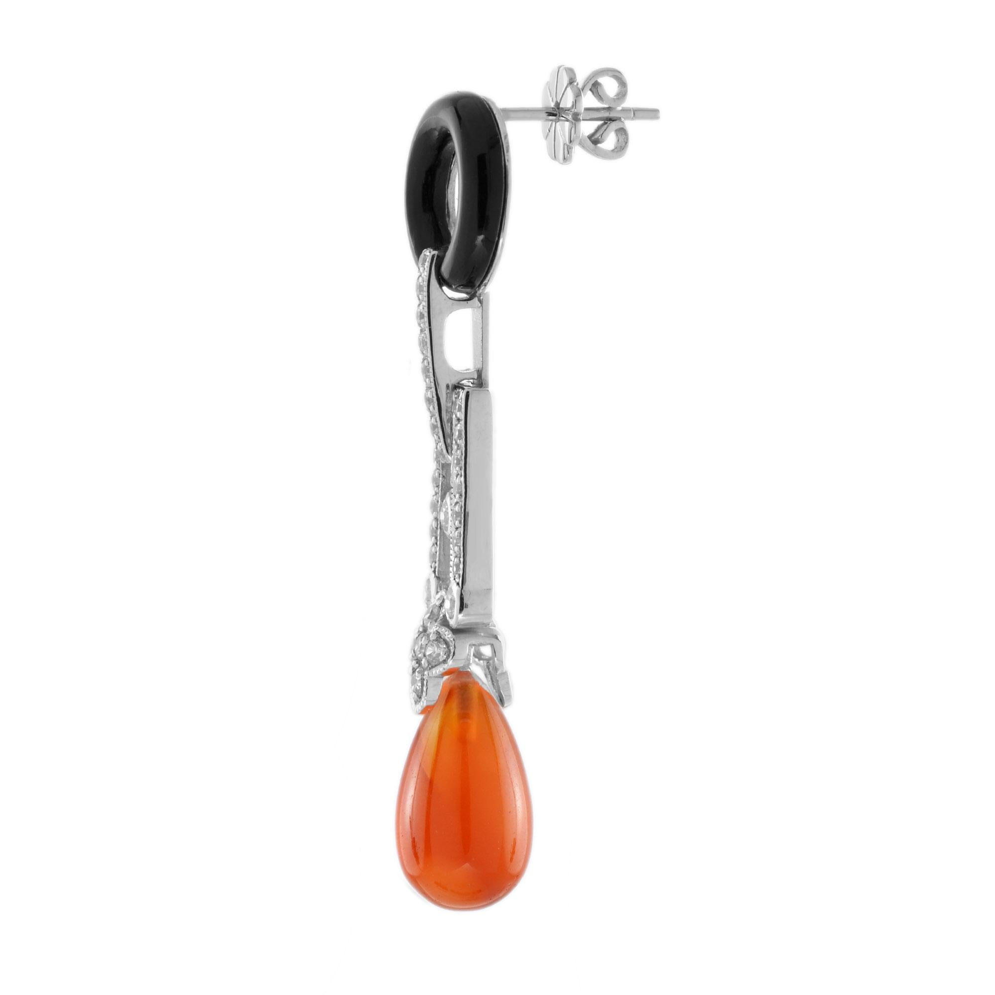 These statement earrings are Art Deco inspired handcrafted using approximately 8.00 carat teardrop shape carnelian. The upper part is decorated with shimmering diamonds, and donut shaped black onyx. Create your signature look with these lovely