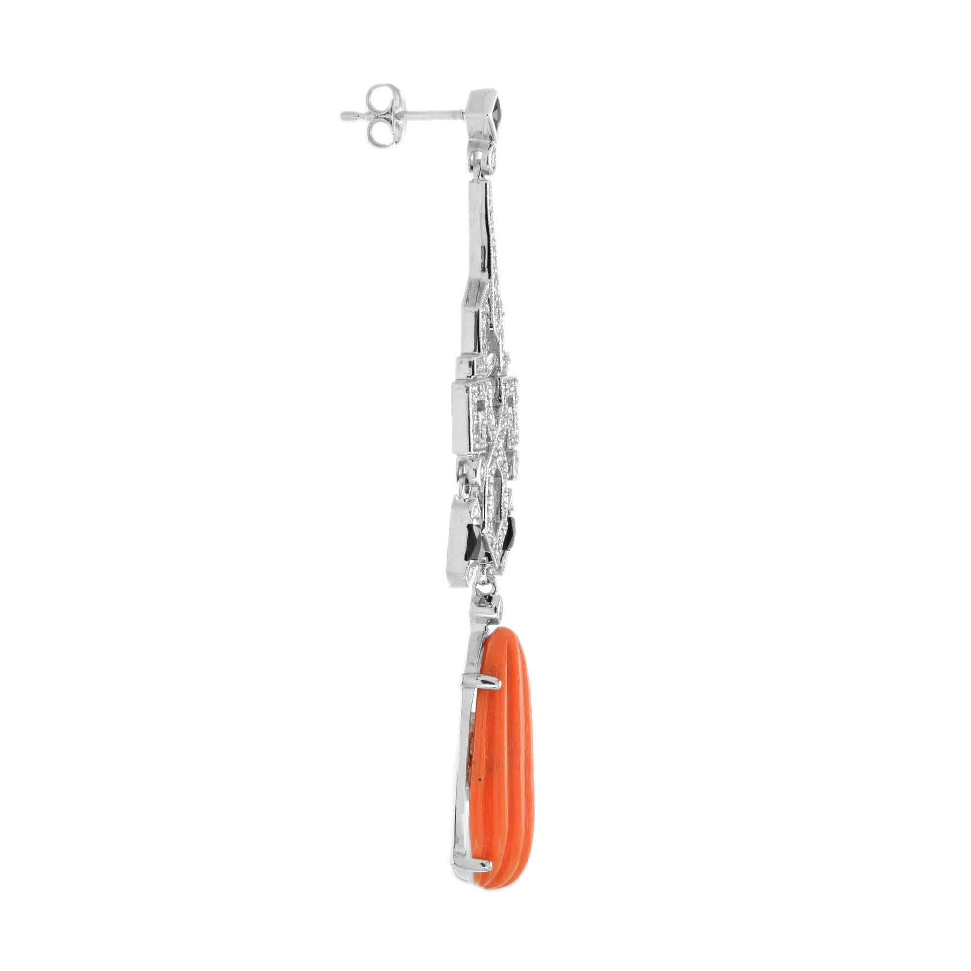 A pair of Art Deco style coral, onyx and diamond earrings, each set with an elongated polished approximately 7.95 coral drop, surmounted by a geometric panel set with diamonds and onyx, mounted in 14k white gold.
Information
Style: Art Deco
Metal: