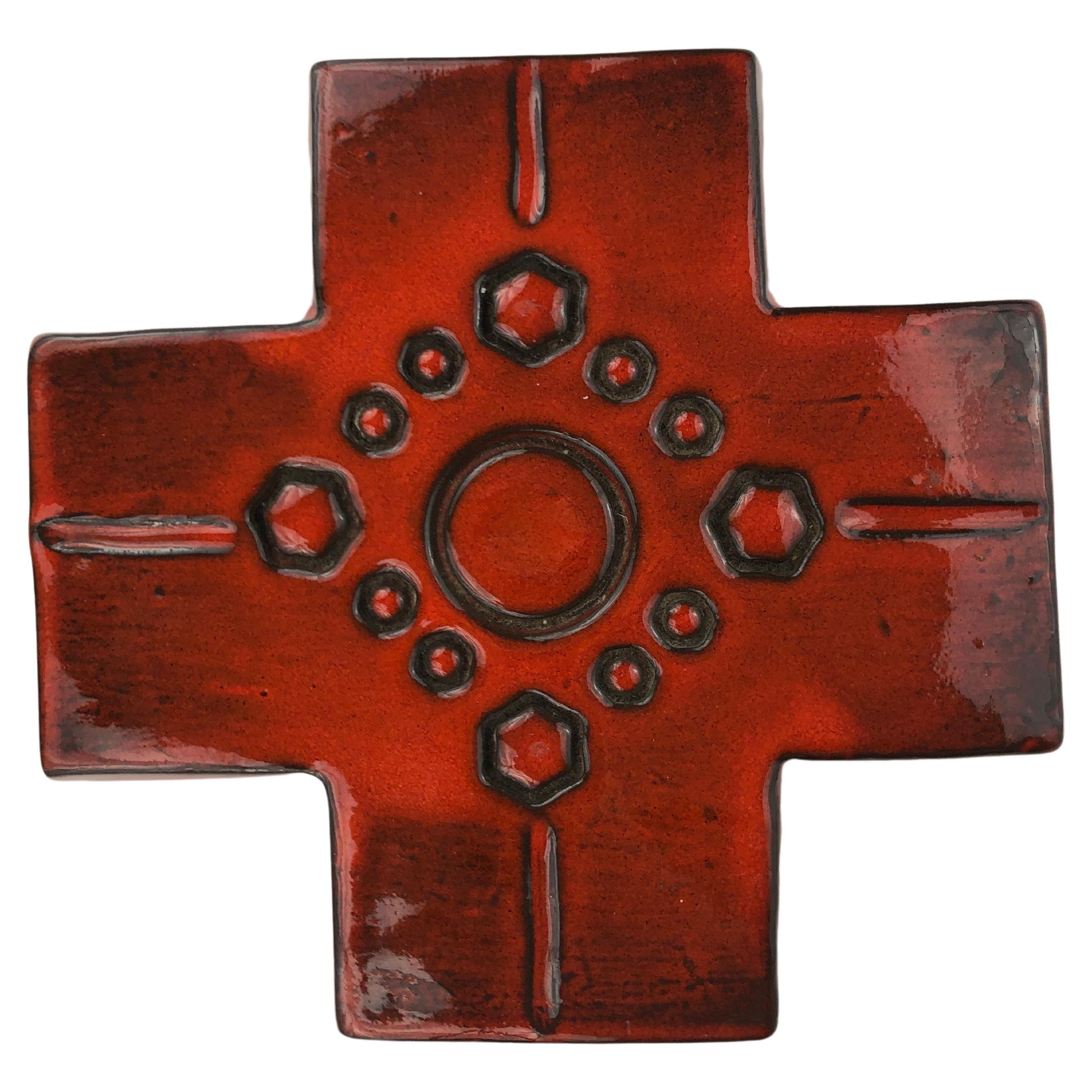 A red-orange, glossy ceramic, midcentury European cross. 

Our large collection of European ceramic crosses consist of an array of handcrafted crosses, each demonstrating the skilled craftsmanship of our dedicated artisans. This vibrant red-orange