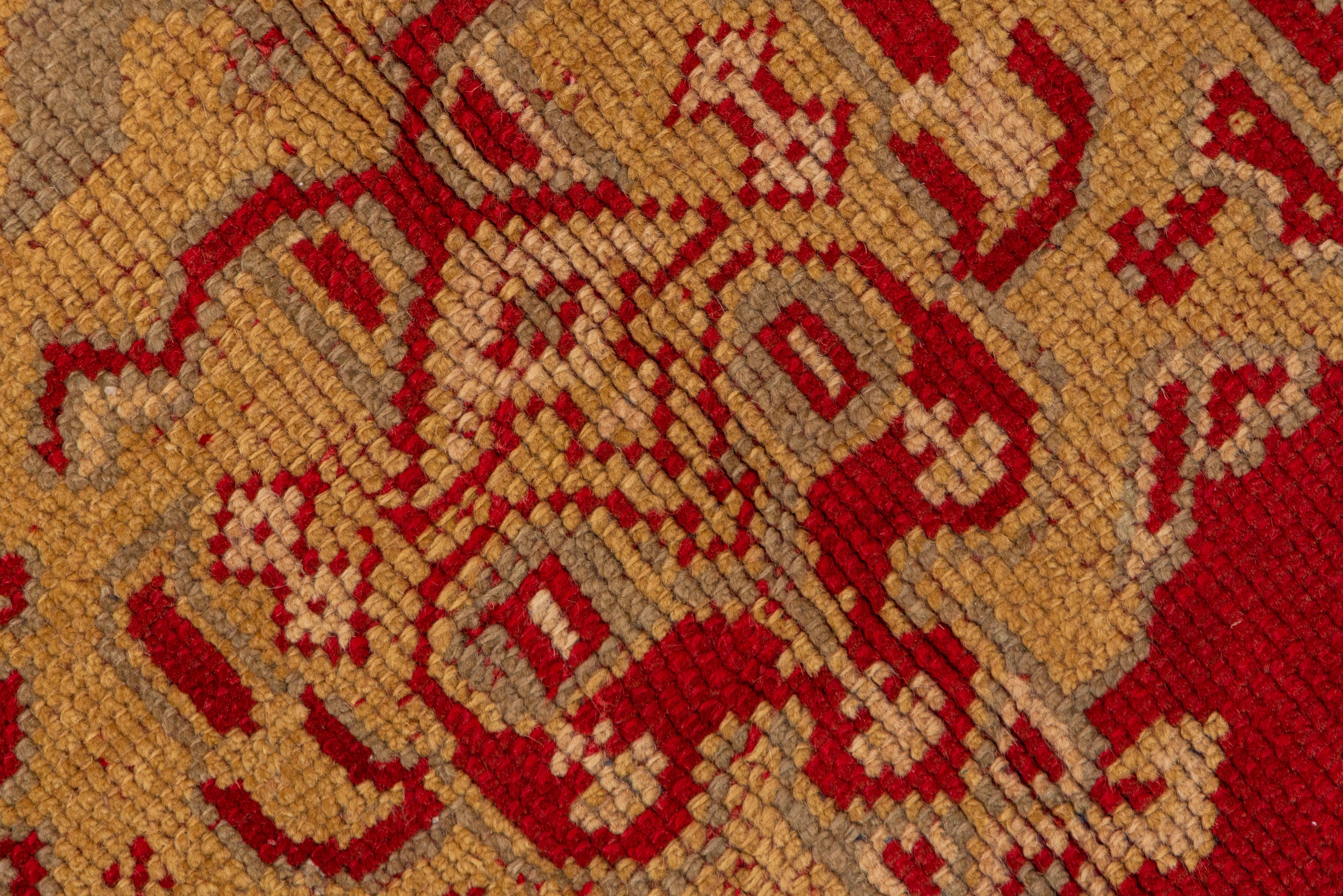 The Turkey red field displays a single central ragged palmette column flanked by half- columns of Yaprak (Leaf) design. The tonally in suite border shows rosettes and hyacinth sprays, with light green and straw details overall.