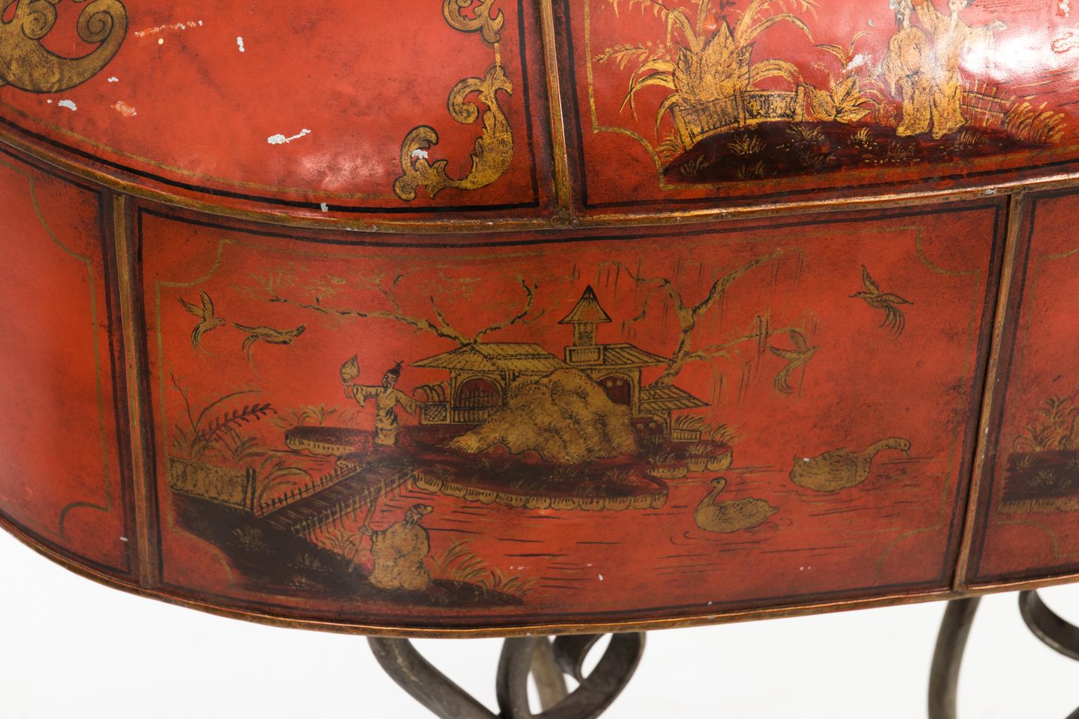 Red painted chinoiserie style metal planter with gold painted landscape scenes on scrolled base, circa early 20th century. Made in France. Please note that wear is consistent with age including surface chips on paint and hammered finish.
