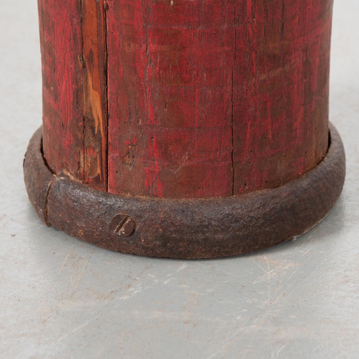 This is a shaped wood column with a round top that has been painted red. An interesting conversation piece or sculpture that would add whimsy to any interior. 
 
