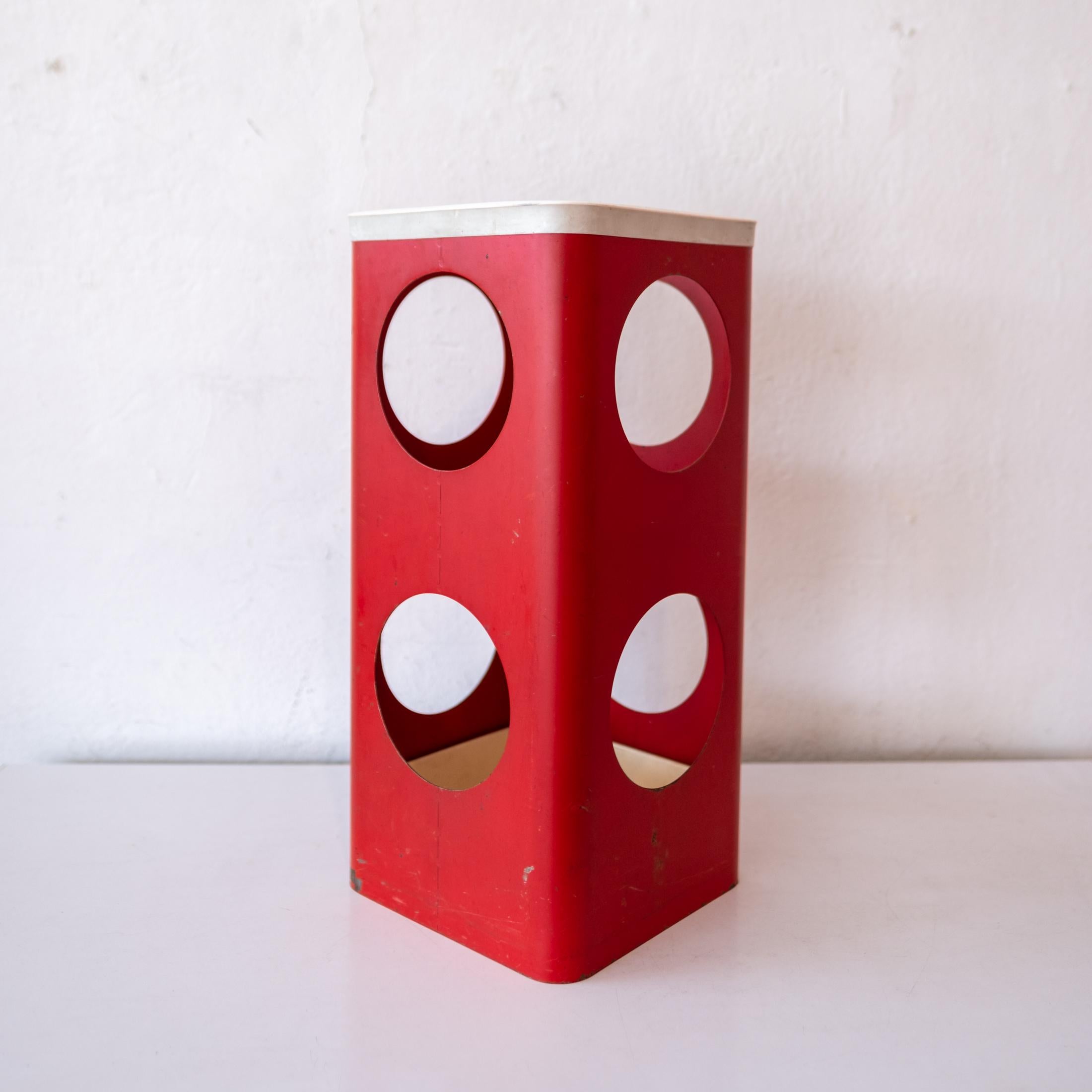 Perforated metal bauhaus umbrella stand. Original red enamel over metal. A great design with a plastic water catcher on the bottom.