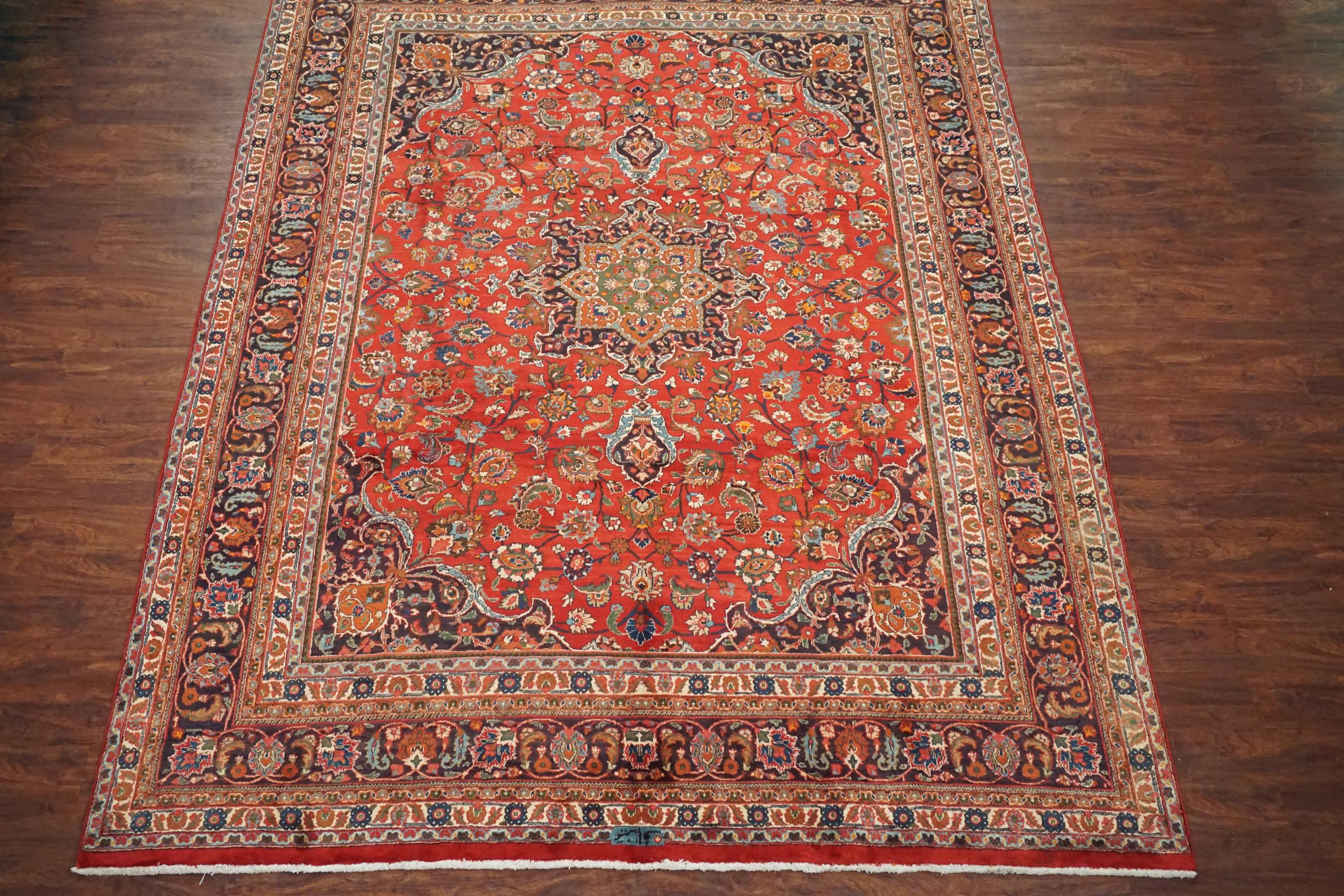 Red Persian Mashad rug,

circa 1940

Measures: 9' 9