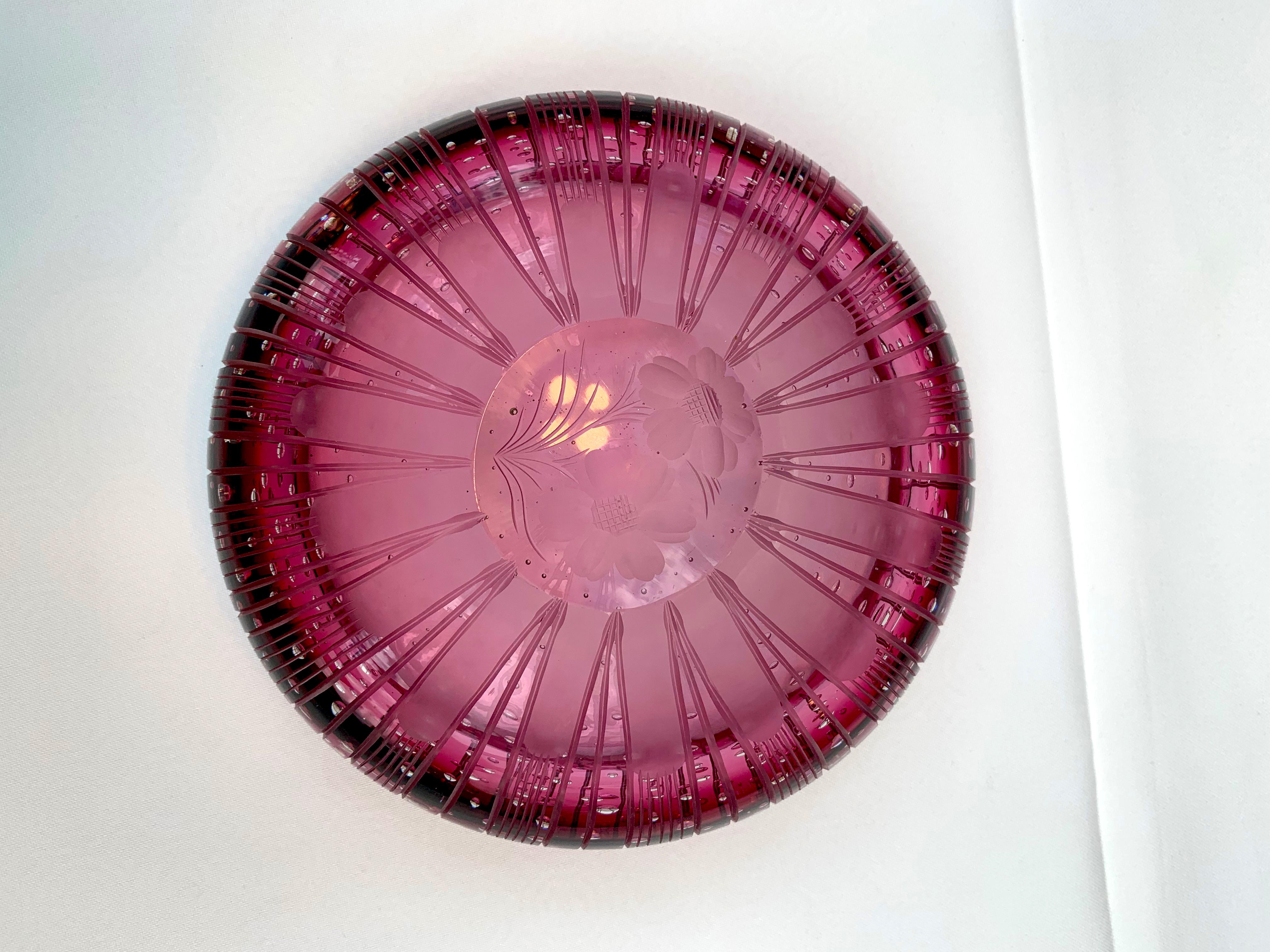 Beautiful red glass bowl hand blown, maybe Murano glass.
Engraved with flower details on the bottom. Unknown manufacture date. Guessing between 1900-2000.