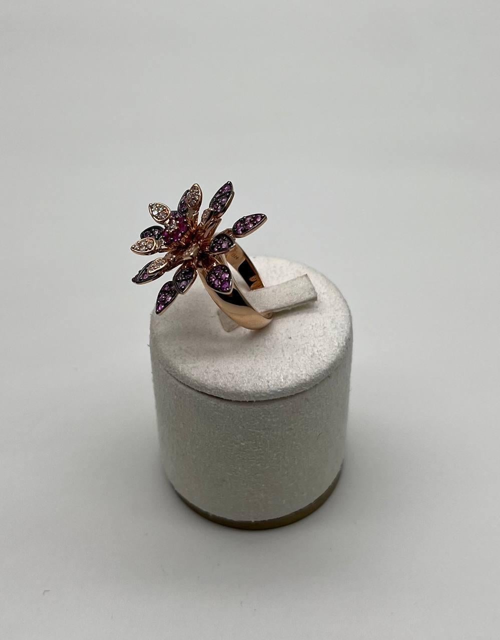 A striking Floral Cocktail Ring, featuring a vibrant array of pink and red rubies set in a flower motif. 14K Rose Gold. 0.30 CTW Diamonds. 1.54 CTW Pink Red Rubies.