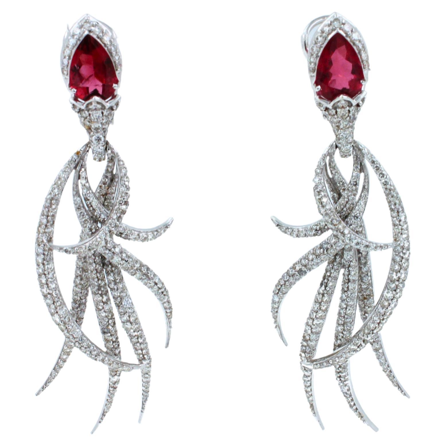 18 Karat White Gold
26 grams
2.70 inches length of earrings
Diamonds 7.50 cts
Red Pink Tourmalines
Pear Cut/Drop Shape
6.00 CTW