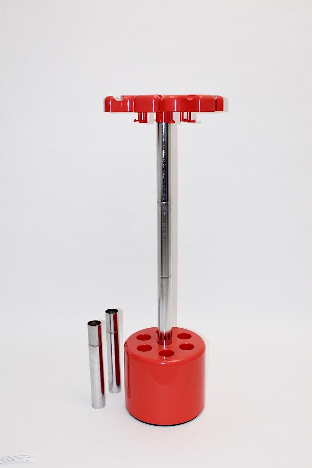 The red plastic and metal vintage coat stand was designed by Roberto Lucchi and Paolo Orlandini circa 1970 for Velca, Legnano, Milano.
The stem features parts, which are stacked one inside another - so you can adjustable the height.
The maximum