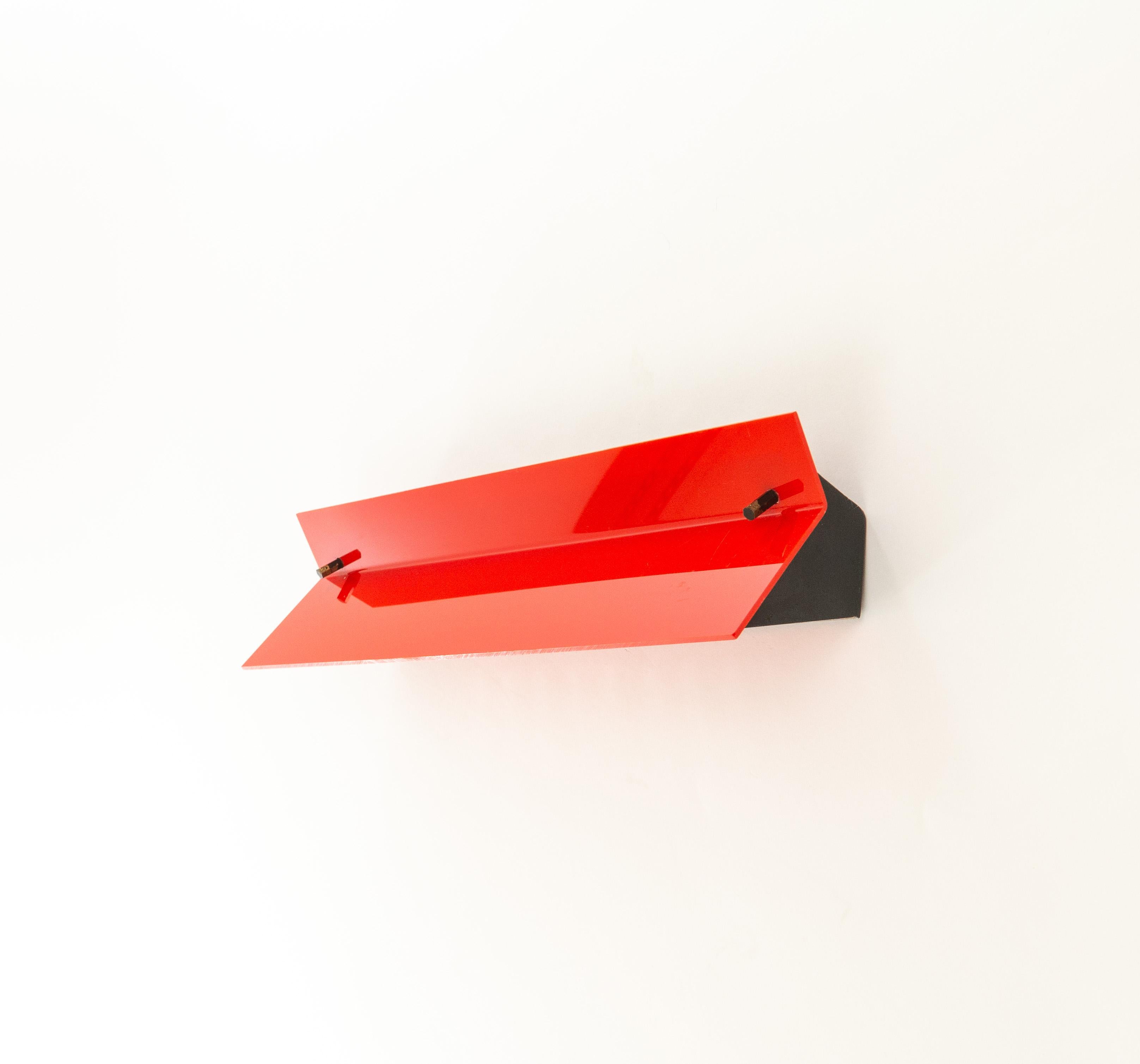 A red wall lamp by lighting manufacturer Stilnovo Milano, designed and produced in the 1960s.

The lamp consists of a lacquered metal structure, red colored plexiglass diffuser and brass and black details.

The Stilnovo label can be found on the