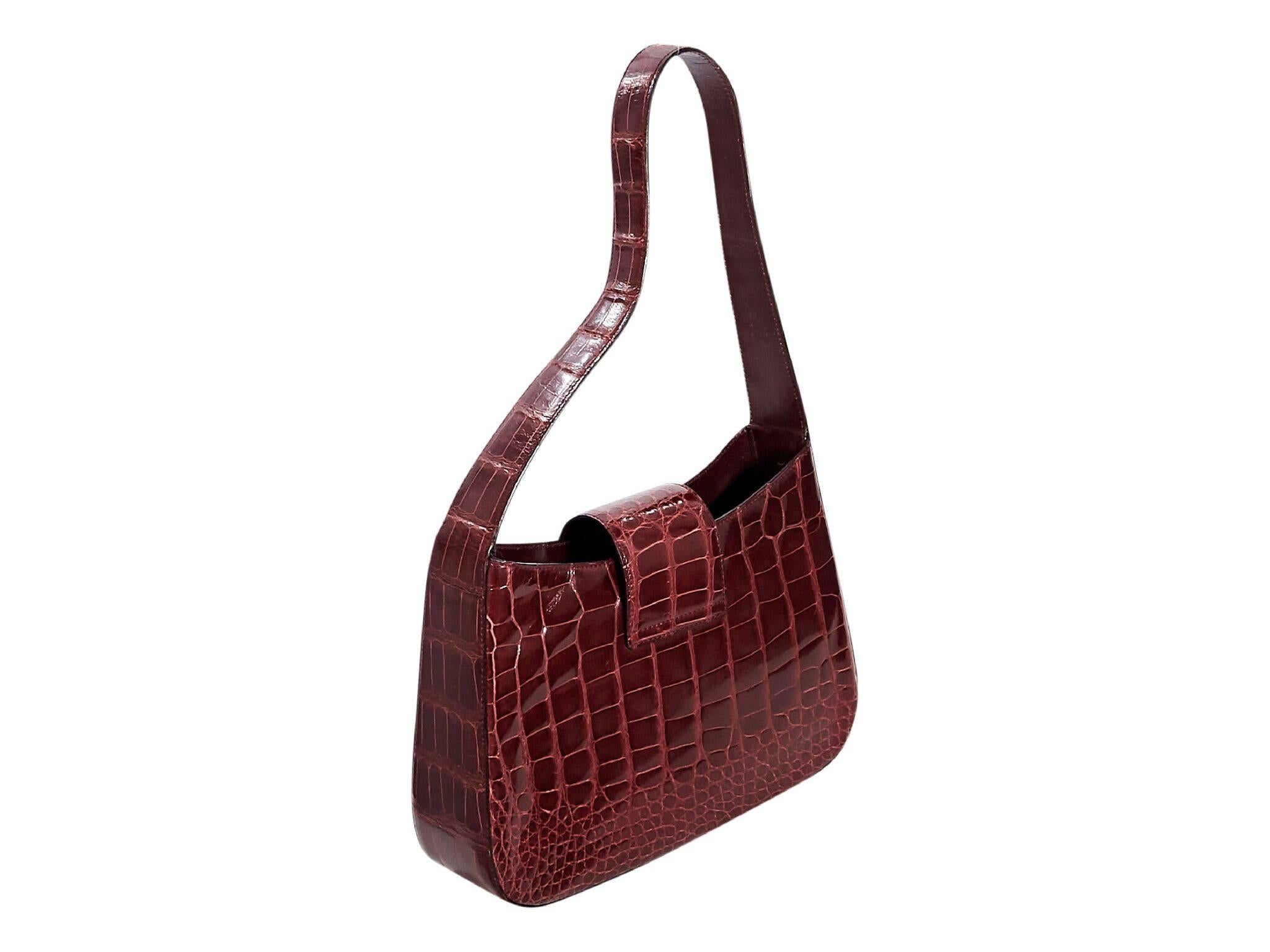 Product details:  Red alligator shoulder bag by Prada.  Single shoulder strap.  Top strap closure.  Lined interior with inner zip pocket.  Silvertone hardware.  Authenticity card included.  11