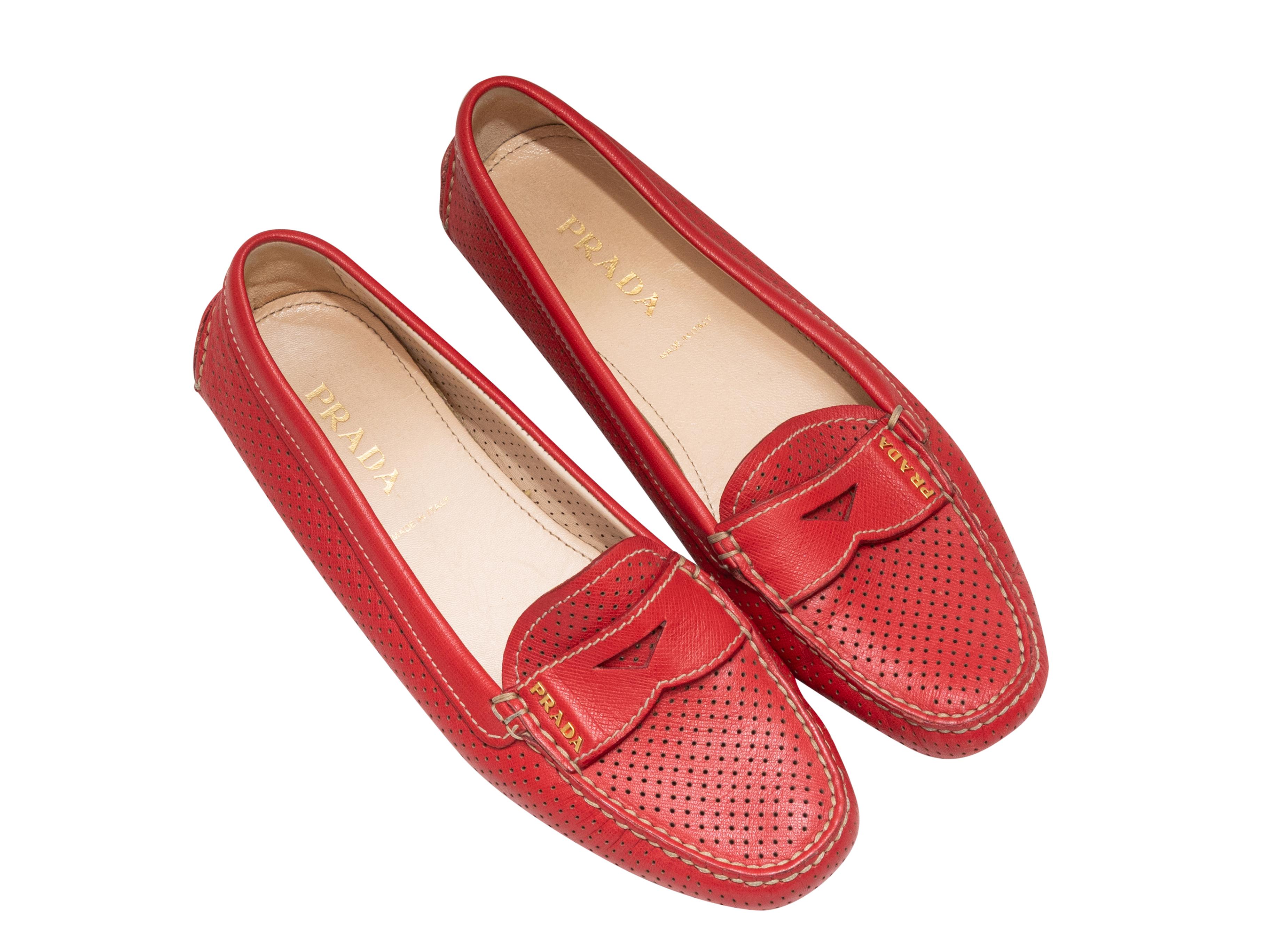 Red perforated leather driving loafers by Prada. Rubber bumpers at bottoms and counters.