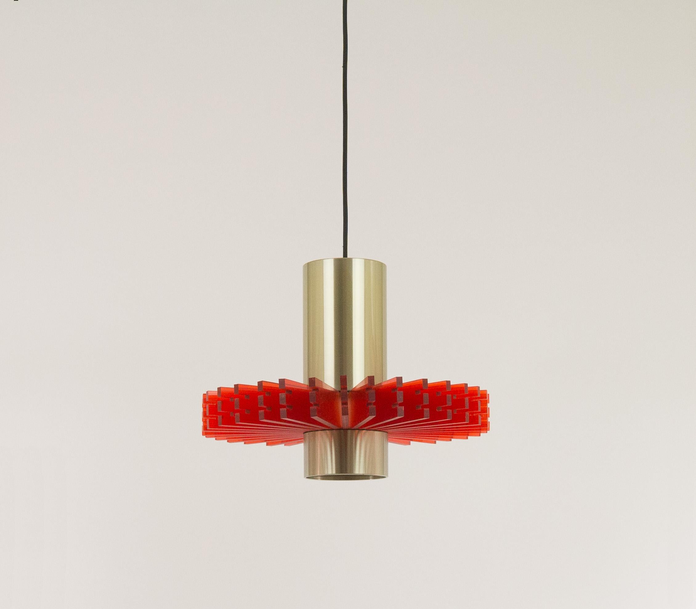 Aluminium and acrylic pendant, nicknamed 'Priest collar', designed by Claus Bolby for Danish lighting manufacturer Cebo in -most probably- the 1960s.

The pendant consists of two round aluminium elements which are joined by 32 yellow pieces of
