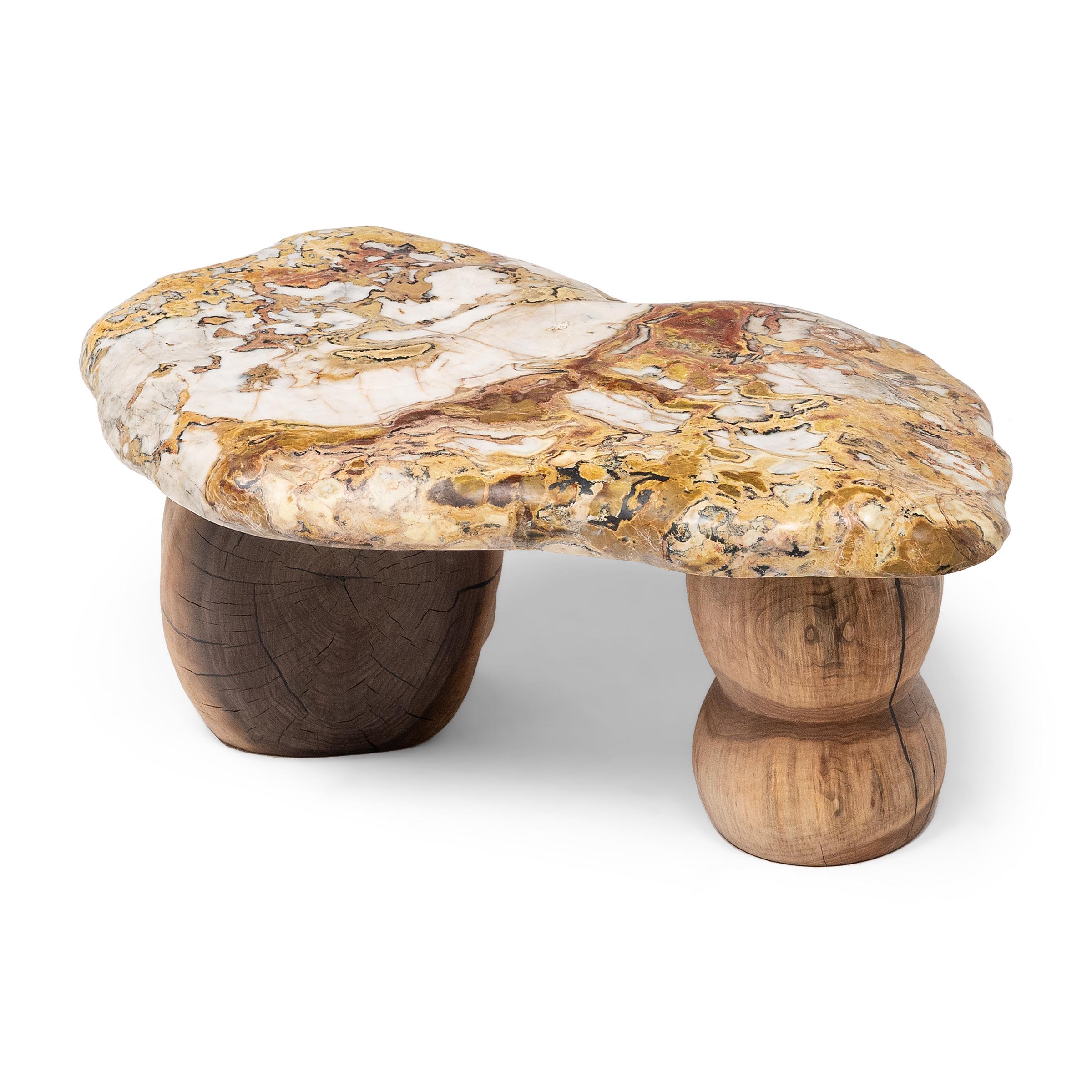 This small stone top table exemplifies Organic Modern style with an emphasis on natural materials. The organic shape and sporadic patterning of the stone slab top calls to mind the irregular beauty of raku ware. A type of Japanese pottery best known