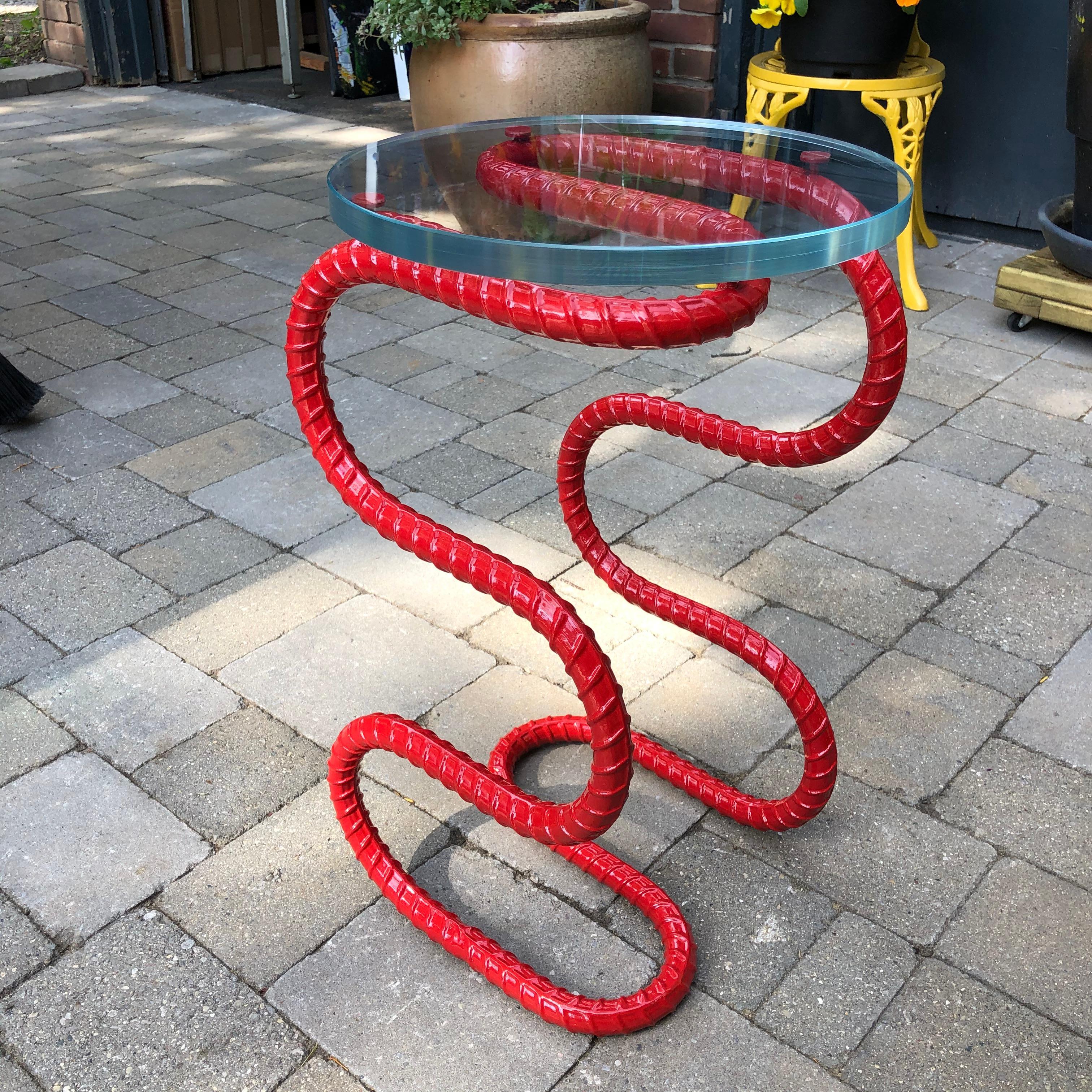 The Cobra side table is part of the Rebar series created by artist Troy Smith. Rebar is the steel used in the forming of concrete to give it strength. Rebar is heated with acetylene torches and red-hot forges, skillfully sculpted by hand and with