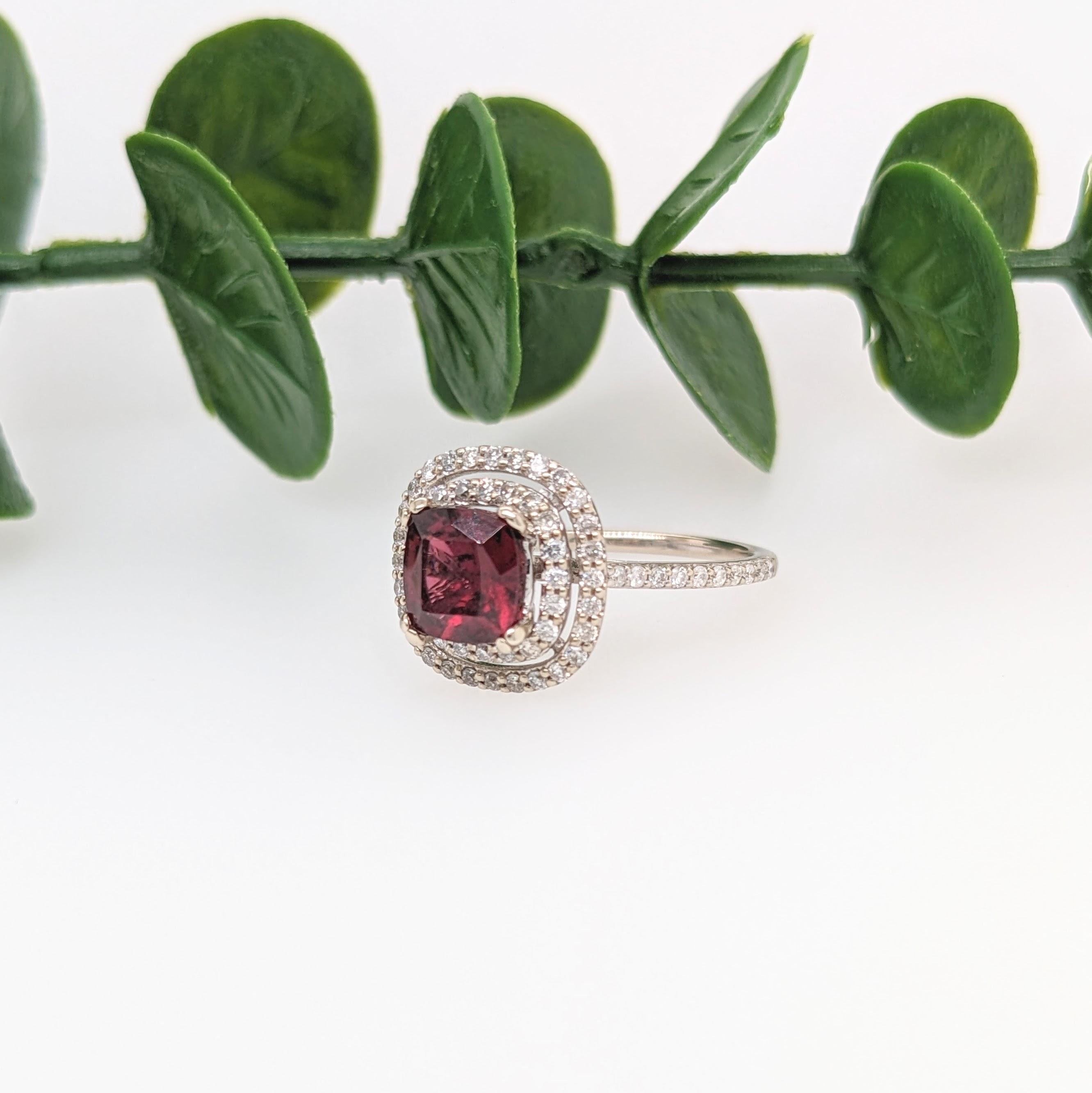 This ring is sure to make a statement with its 6mm cushion cut Red Rhodolite center stone, embellished with beautiful double halo of diamond accents in solid 14k White Gold.

Specifications

Item Type: Ring
Center Stone: Rhodolite
Treatment: